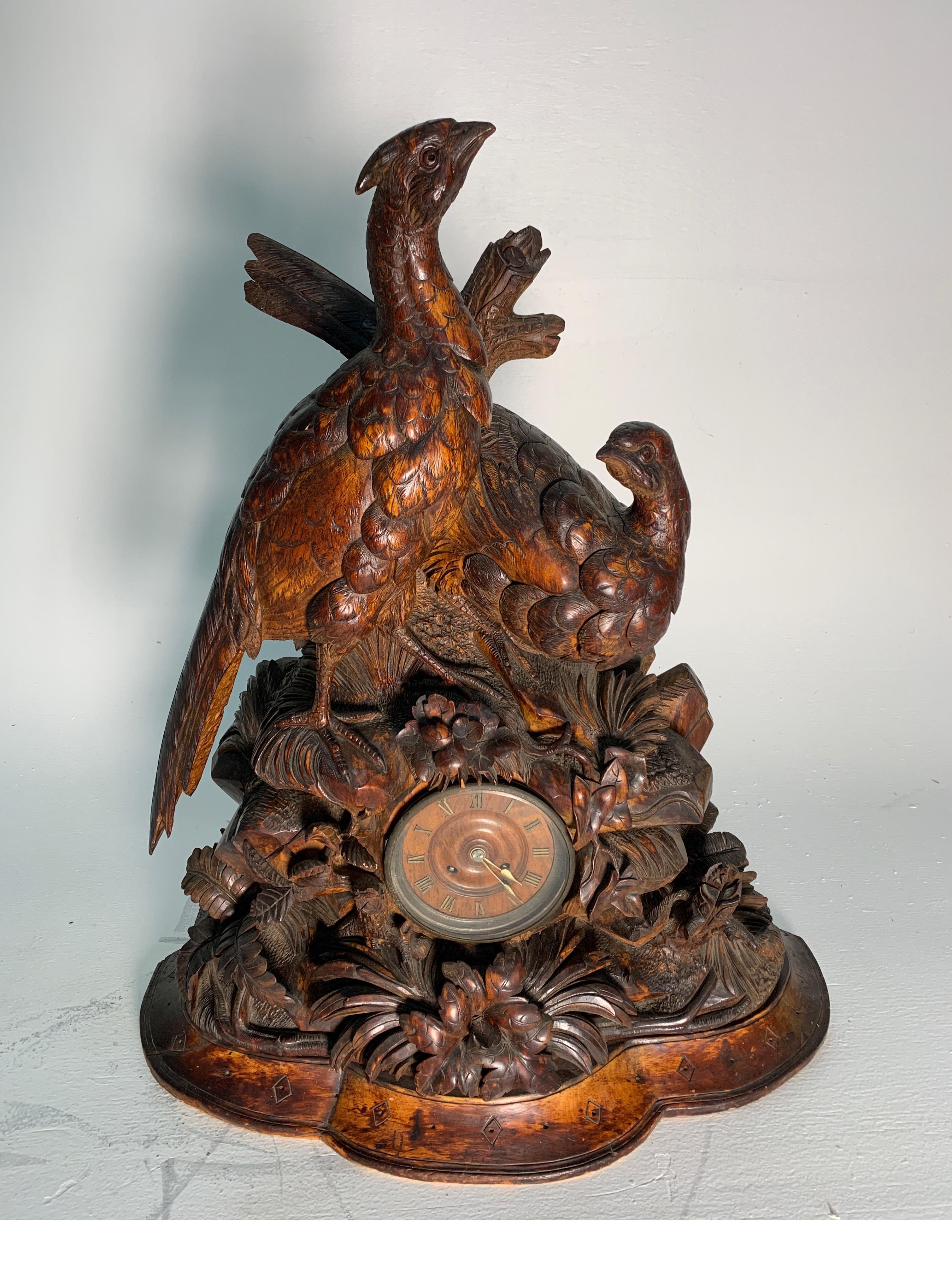 A Large and finely carved German Black Forest chiming clock. The top with two pheasants in a woodland setting with lower clock with wood face. Totally hand carved, 19th century, 1870-1880.