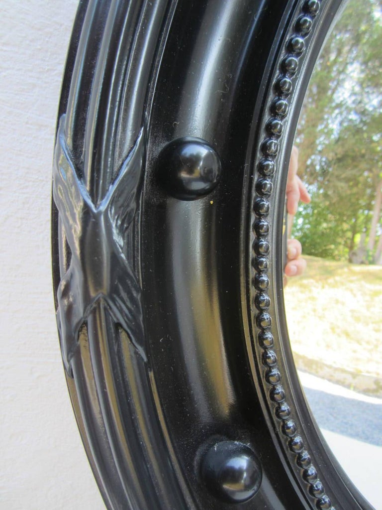 Large Regency style black painted frame with convex mirror.