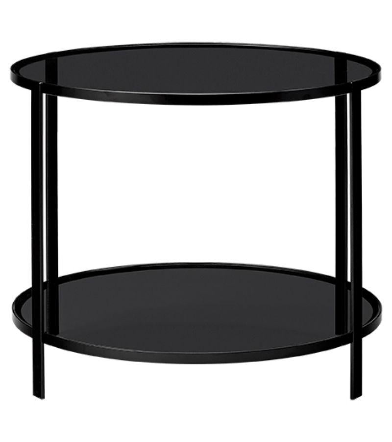 Large black glass contemporary side table
Dimensions: Diameter 58 x height 40 cm 
Materials: Powder-coated iron, tempered glass.


Fumi is an elegant range of coffee tables that looks very light with its black iron frames and tabletops made of