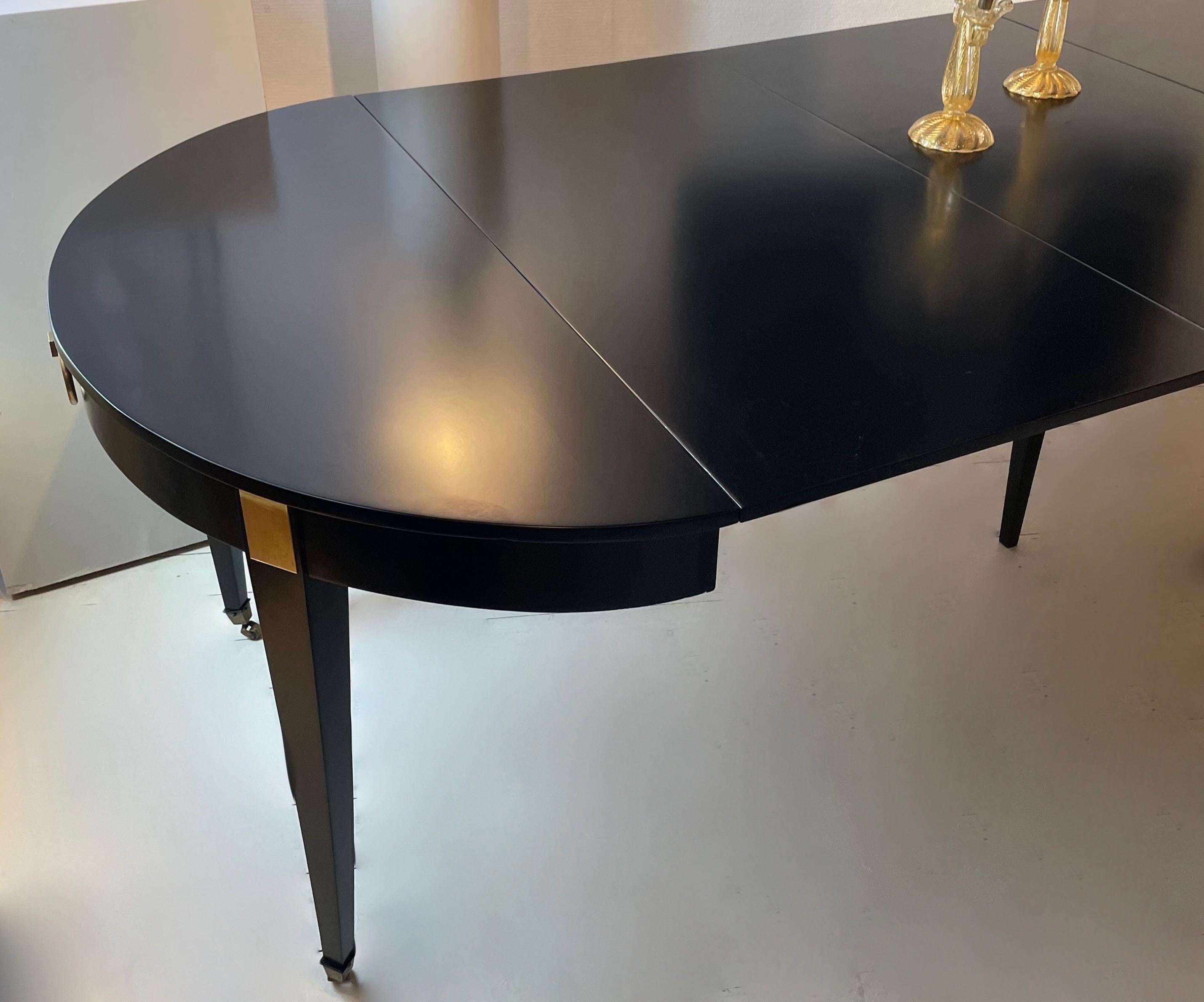 Elegant black lacquered extending dining room table (3 leaves) on casters with pull rings.
Minimal brass details. 3 leaves ( 60 cm -115 cm each)
In the style of Louis XVI, the table can seat 10 to 12 people.
By Maison Jansen, Paris ,circa 1955.
