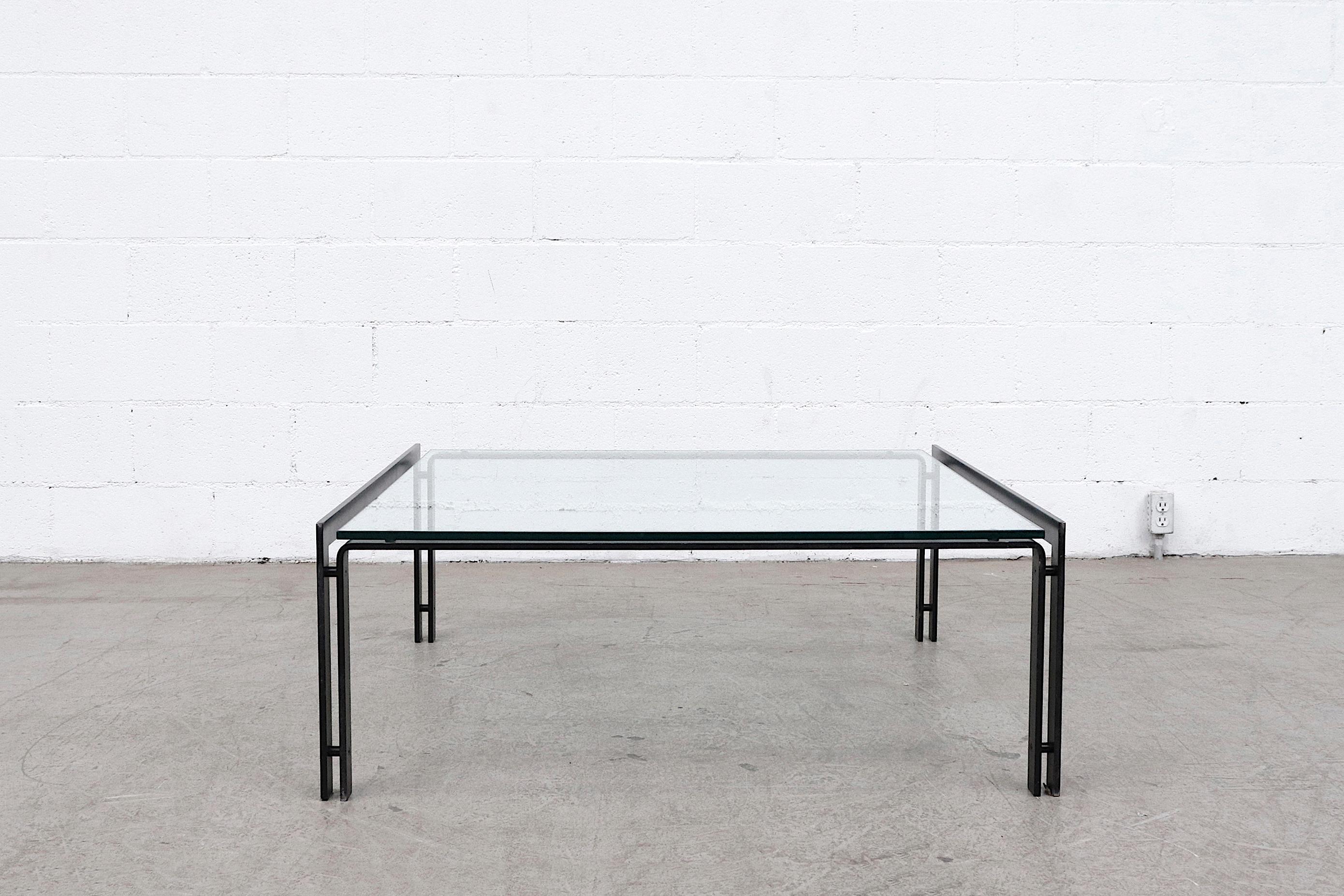Large Metaform coffee table with double banded black enameled frame and heavy plate glass top. In original condition with some frame wear and scratches.
