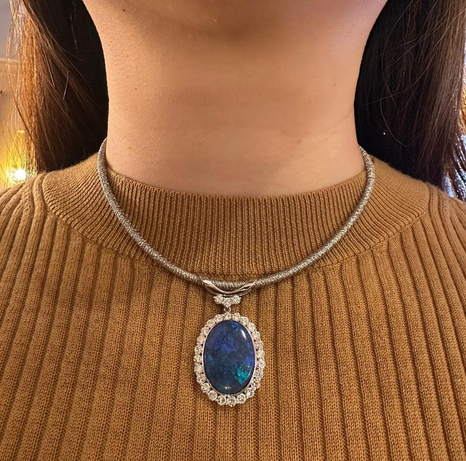GIA Certified Black Opal and Diamond Pendant Necklace in Platinum and 18k White Gold

Black Opal and Diamond Necklace features an 18.86 carat Natural Oval Black Opal with a color play of Royal Blue and Bright Green on a Black background surrounded