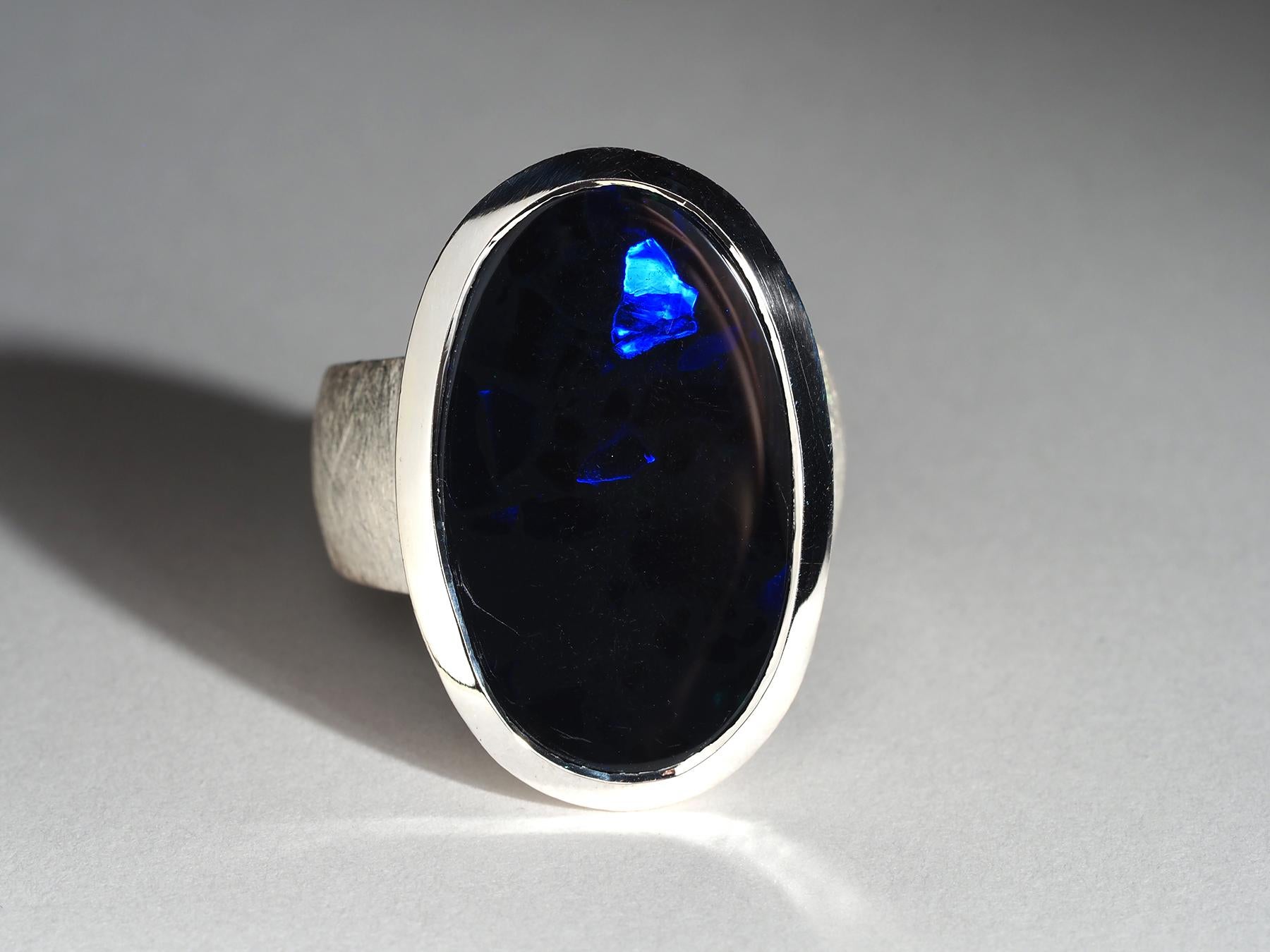 Large solid sterling silver ring with natural oval-cut Black Opal - tone N1
opal origin - Australia
opal measurements - 0.59 х 0.98 in / 15 х 25 mm
opal weight - 16.7 ct 
ring weight - 16.5 grams
ring size -  9.25 US / 60 EU / 19.25 / N20
All