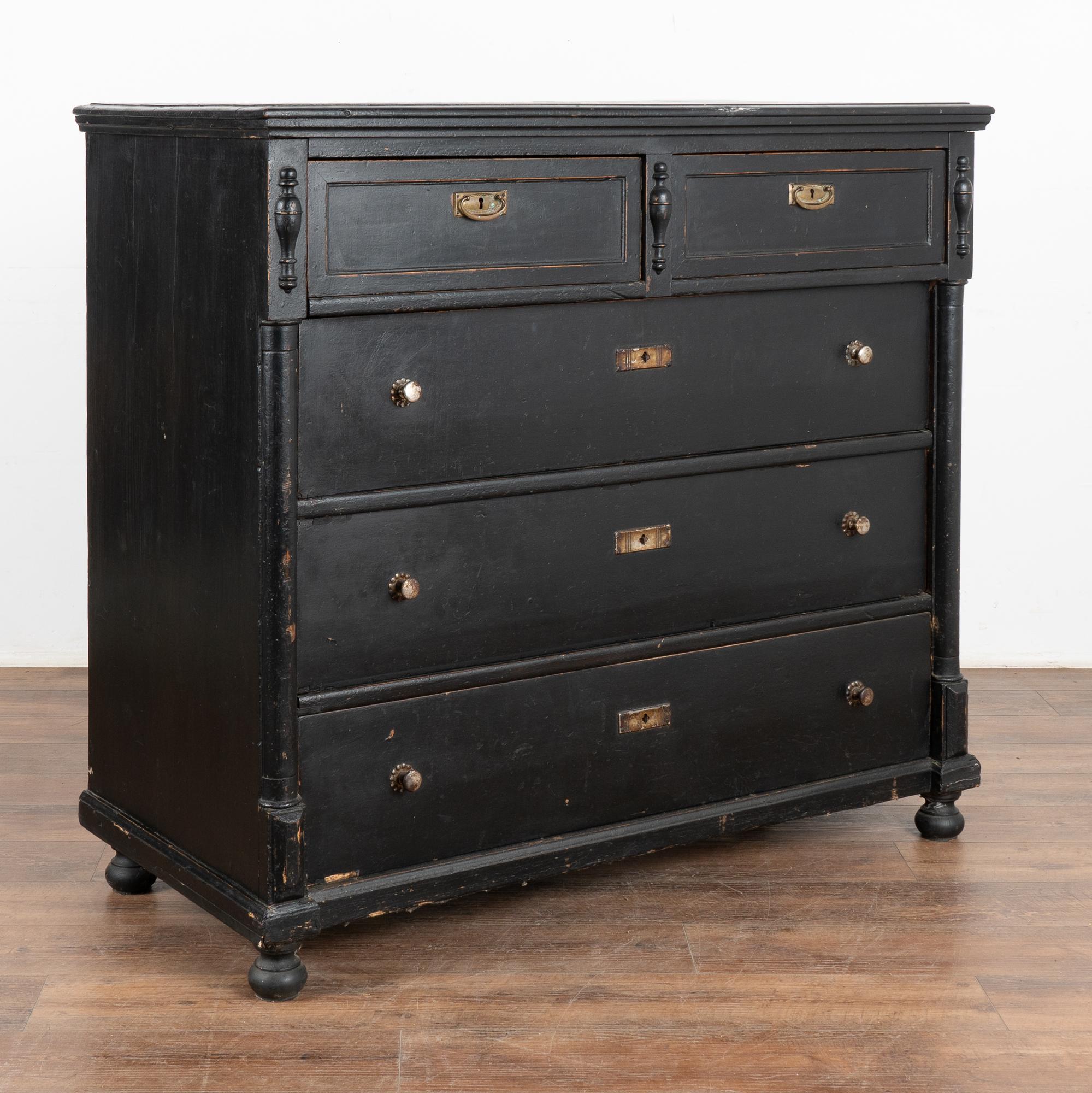 This large pine chest of drawers features two smaller drawers over three large drawers and is raised on bun feet.
The black paint is old, but likely not original to the blanket chest. Generations of use are revealed in the many scratches, nicks, and