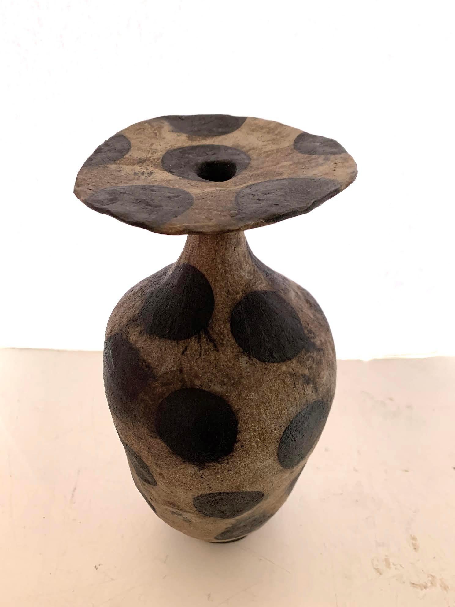Contemporary American ceramicist Brenda Holzke made unique one of a kind ceramic vase that is hand built and made of various colors. 
Recycled stoneware clay with iron oxide stain dots.
Decorative large black polka dots on a light brown base.
