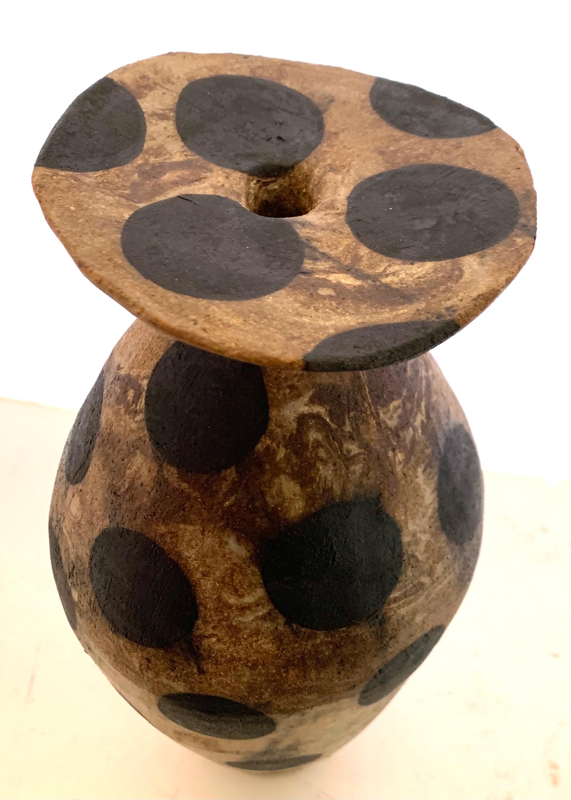 Contemporary American ceramicist Brenda Holzke unique one of a kind ceramic vase that is hand built and made of various colors 
of recycled stoneware clay with iron oxide stain dots.
Decorative large black polka dots on shades of light brown