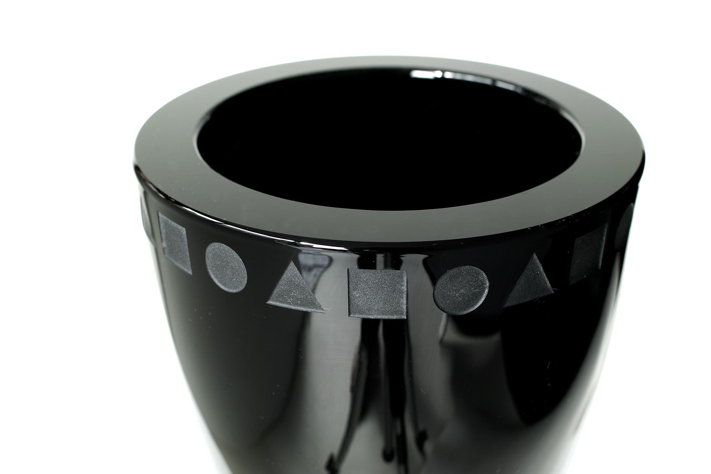 We offer free curbside viewing of this item to the five boroughs of New York City.

Deep, glossy black crystal in elegantly minimal form with thick, heavy walls, etched geometric pattern, etched signature on bottom, flat cut polished top,