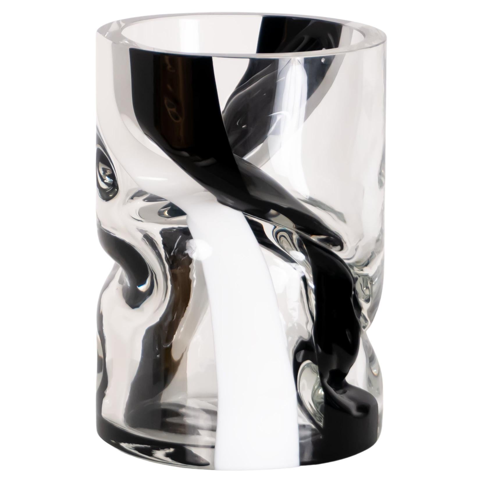 Our large striped Crushed vase features a bold black stripe on a clear glass vessel. During the glass blowing process, vases are twisted and shaped to create crushed forms within the confines of a simple geometric framework. Each piece is unique.