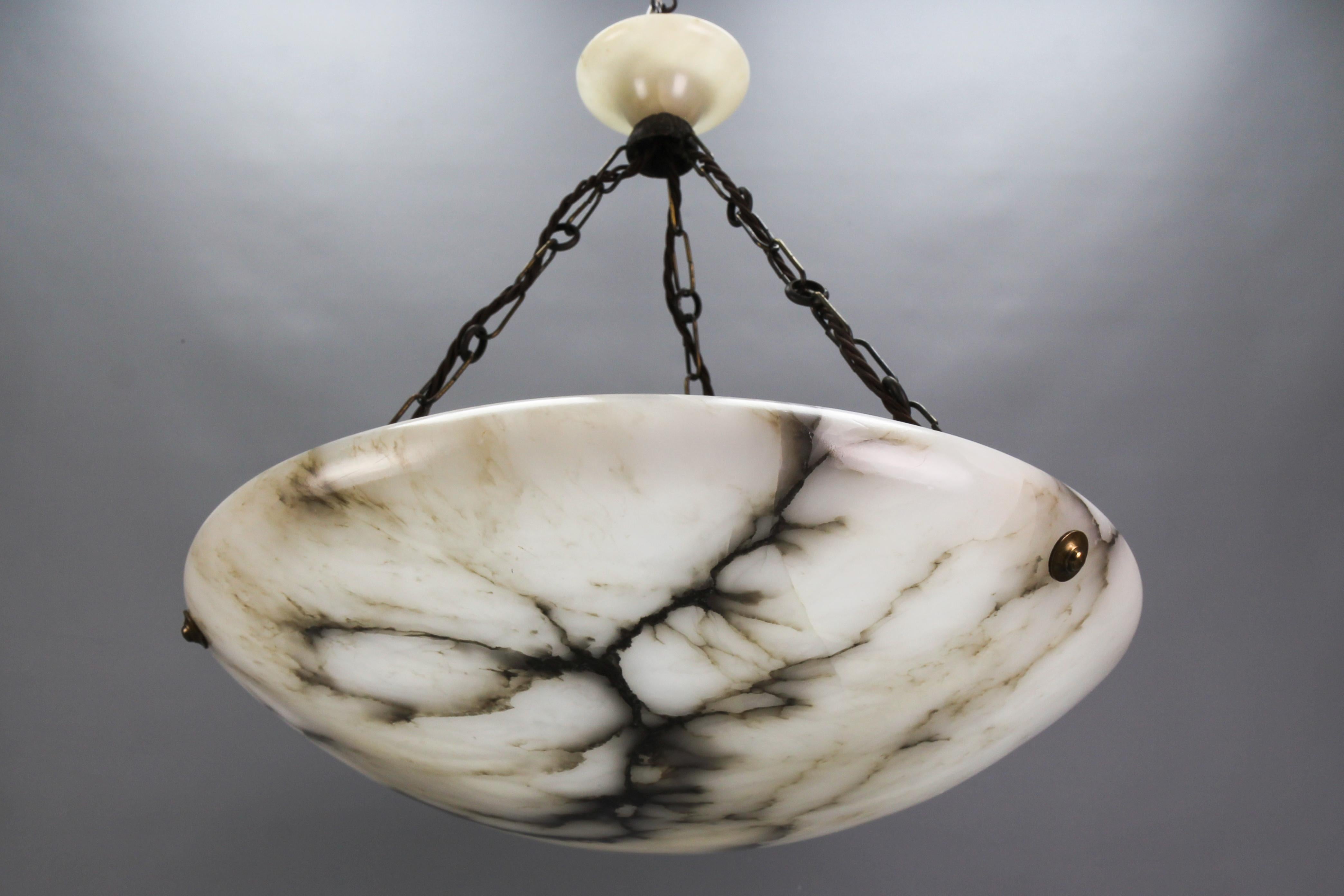 Large black veined white and grey alabaster and brass pendant light fixture, France, circa the 1920s.
An impressive and wonderful alabaster pendant ceiling light fixture from circa the 1920s. Beautifully veined and masterfully carved white and light
