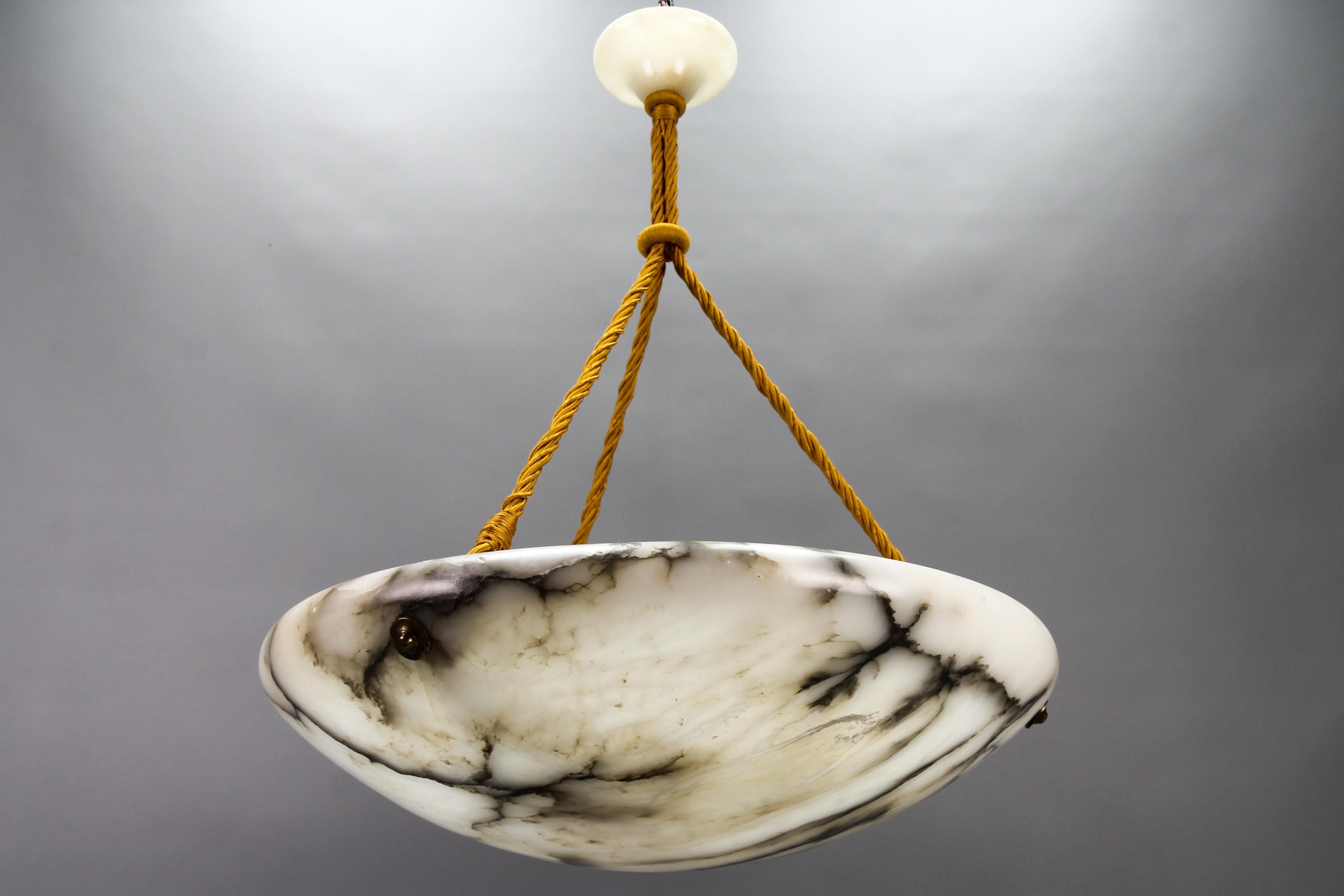 Large Black Veined White and Grey Alabaster Pendant Light Fixture, France, circa the 1920s.
An impressive and wonderful alabaster pendant ceiling light fixture from circa the 1920s. Beautifully veined and masterfully carved white and light grey