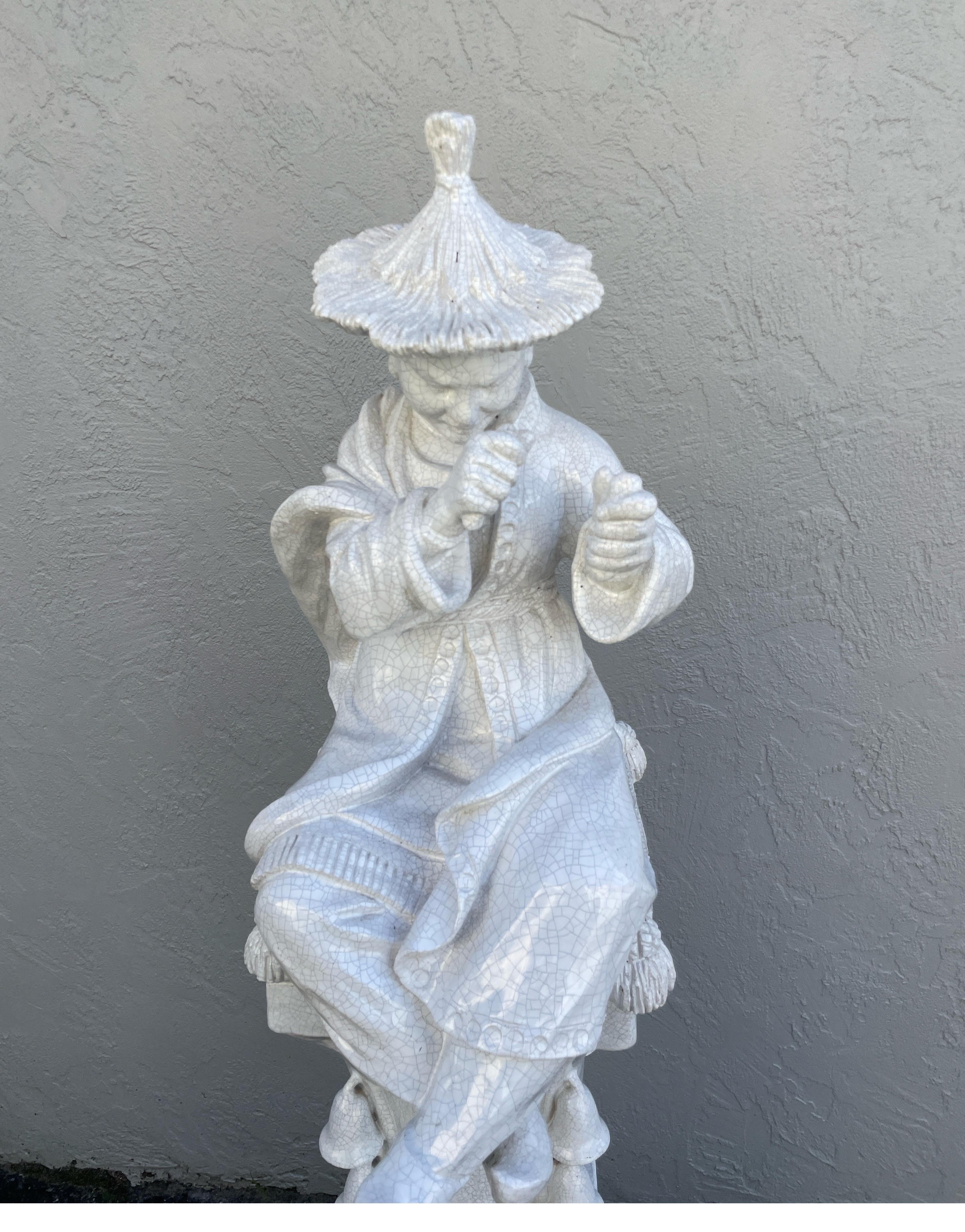 Large Italian White glazed Terra Cotta Chinoiserie Figure on a pedestal. The pedestal is divided into three sections.