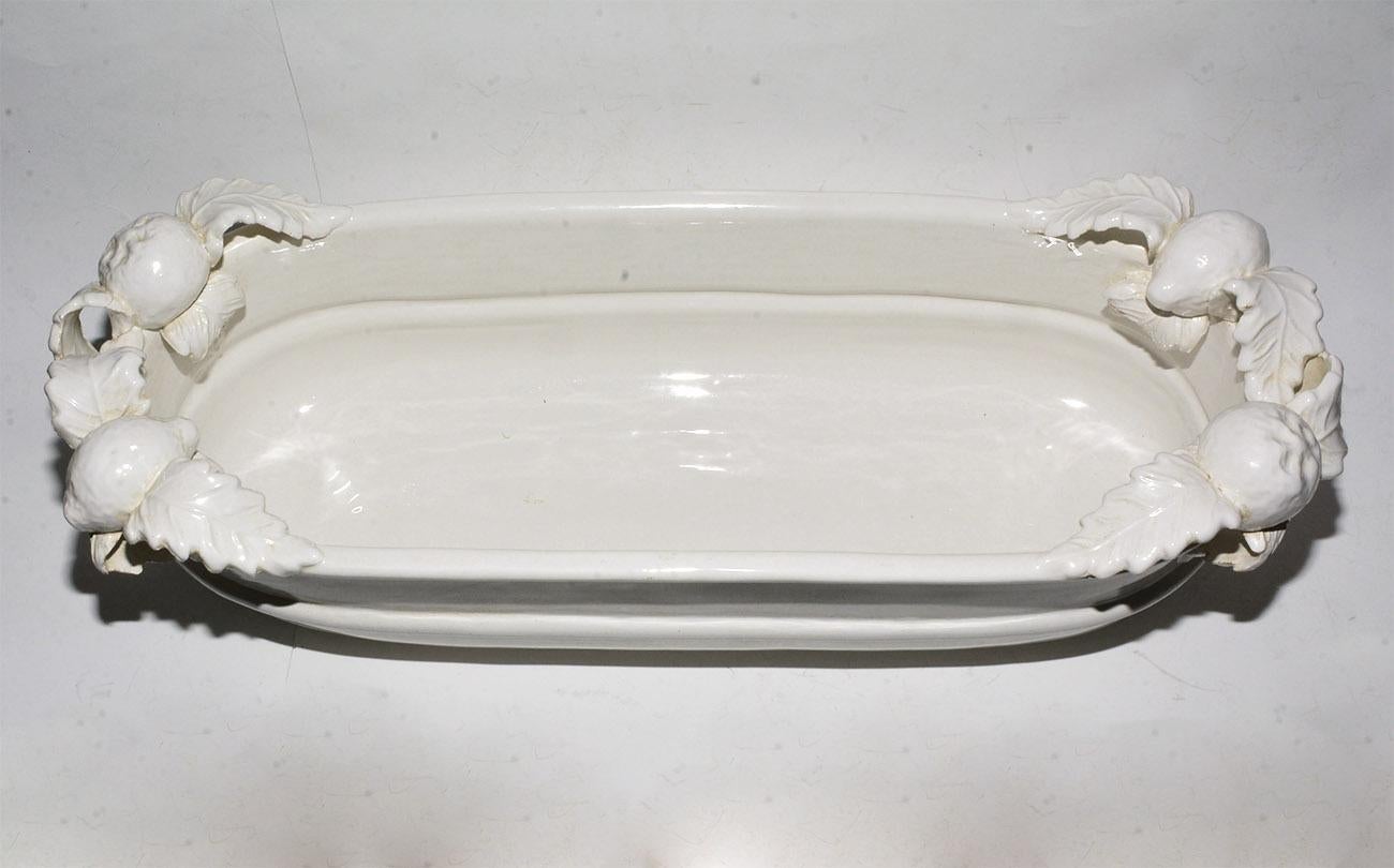 The large blanc de chine glazed porcelain trough is in the style of Italian country pottery. The trough form centerpiece is decorated with hand made ceramic lemons and oranges. Wonderful as a serving piece. 7 inches x 24 inches x 8 inches.