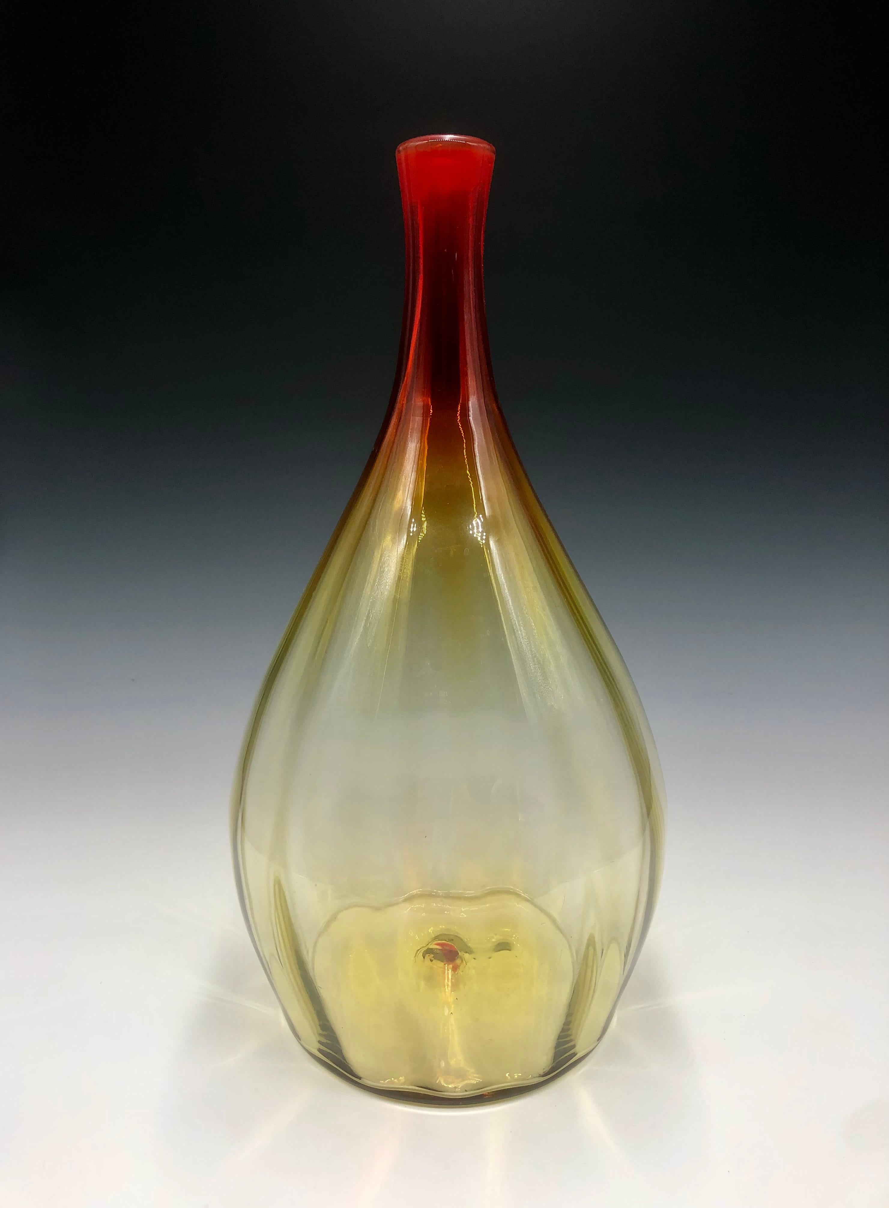 Gorgeous mid-century modern large oversized Blenko Amberina hand-blown ribbed vase/vessel. A deep red neck that subtly transitions into a pale yellow body.

Size: 17.5