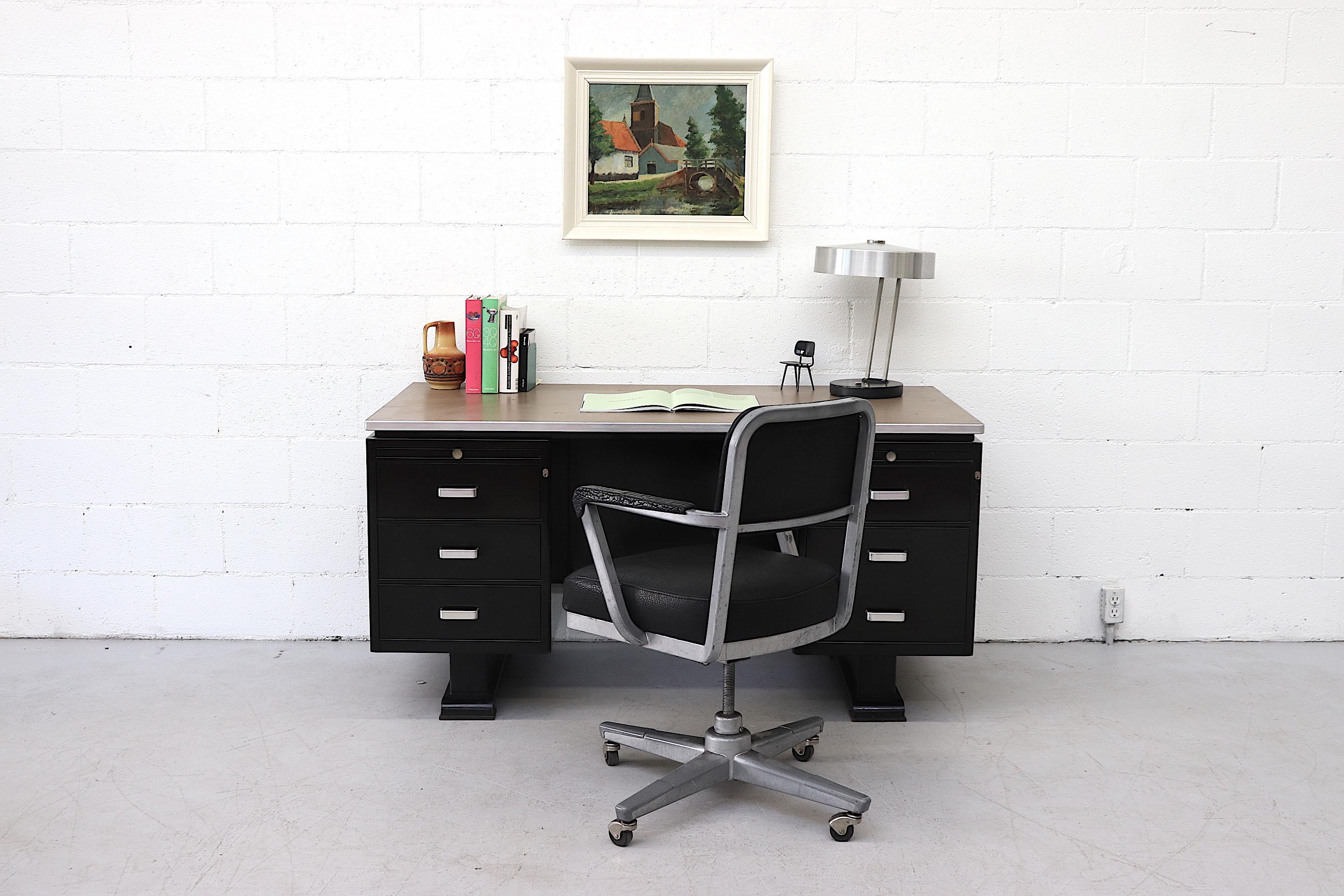 Vintage large black enameled Industrial Van Blerk Tilburg desk with grey laminate top and 6 pullout / pull-out drawers. Executive style desk with built in document trays and aluminum handles. Shown with buffalo leather office chair (S332) and