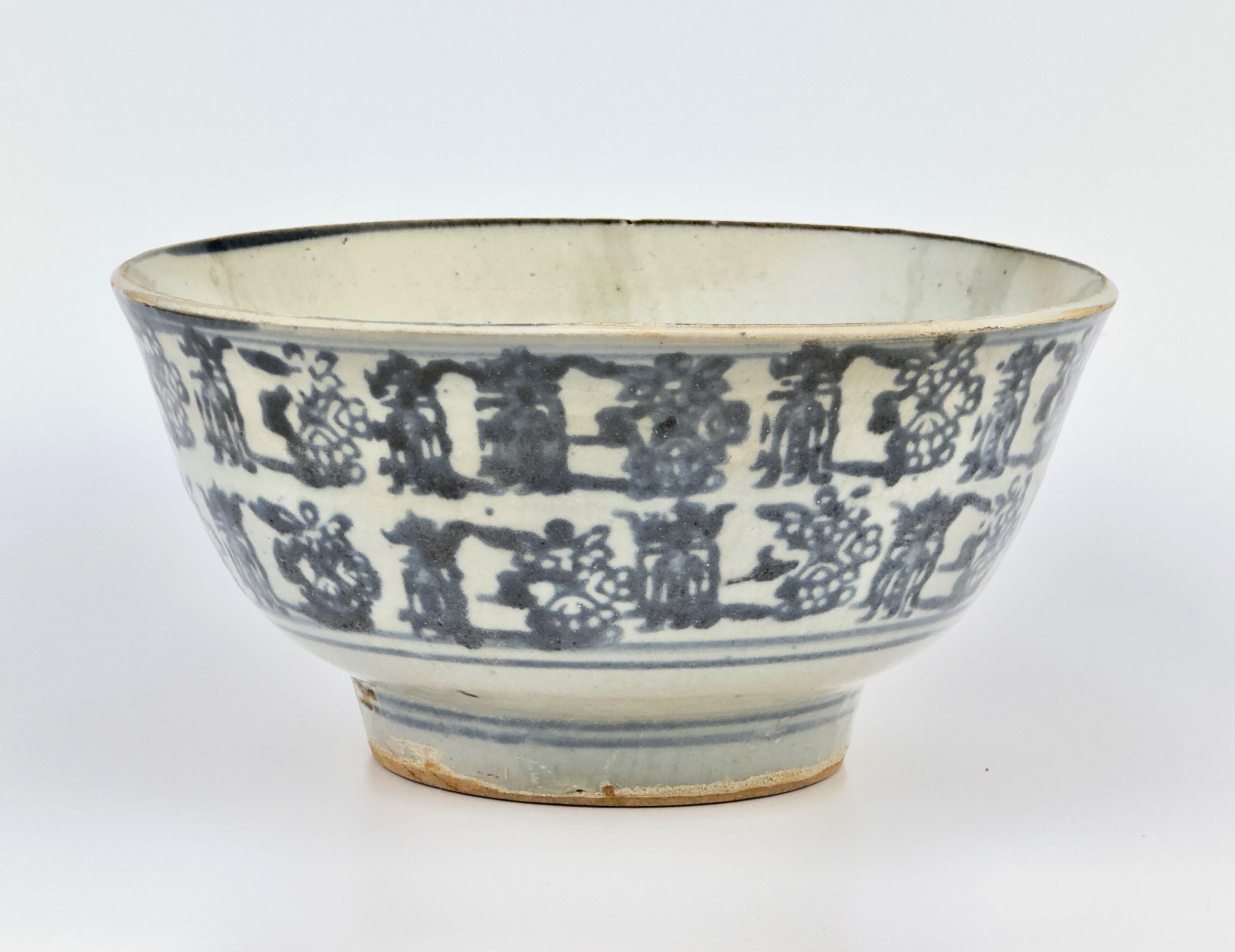 This impressive, large-sized circular bowl, featuring hues of blue and white, showcases decoration through a block print technique. It is adorned with two horizontal bands of shou characters, which alternate with intricate floral motifs, all set