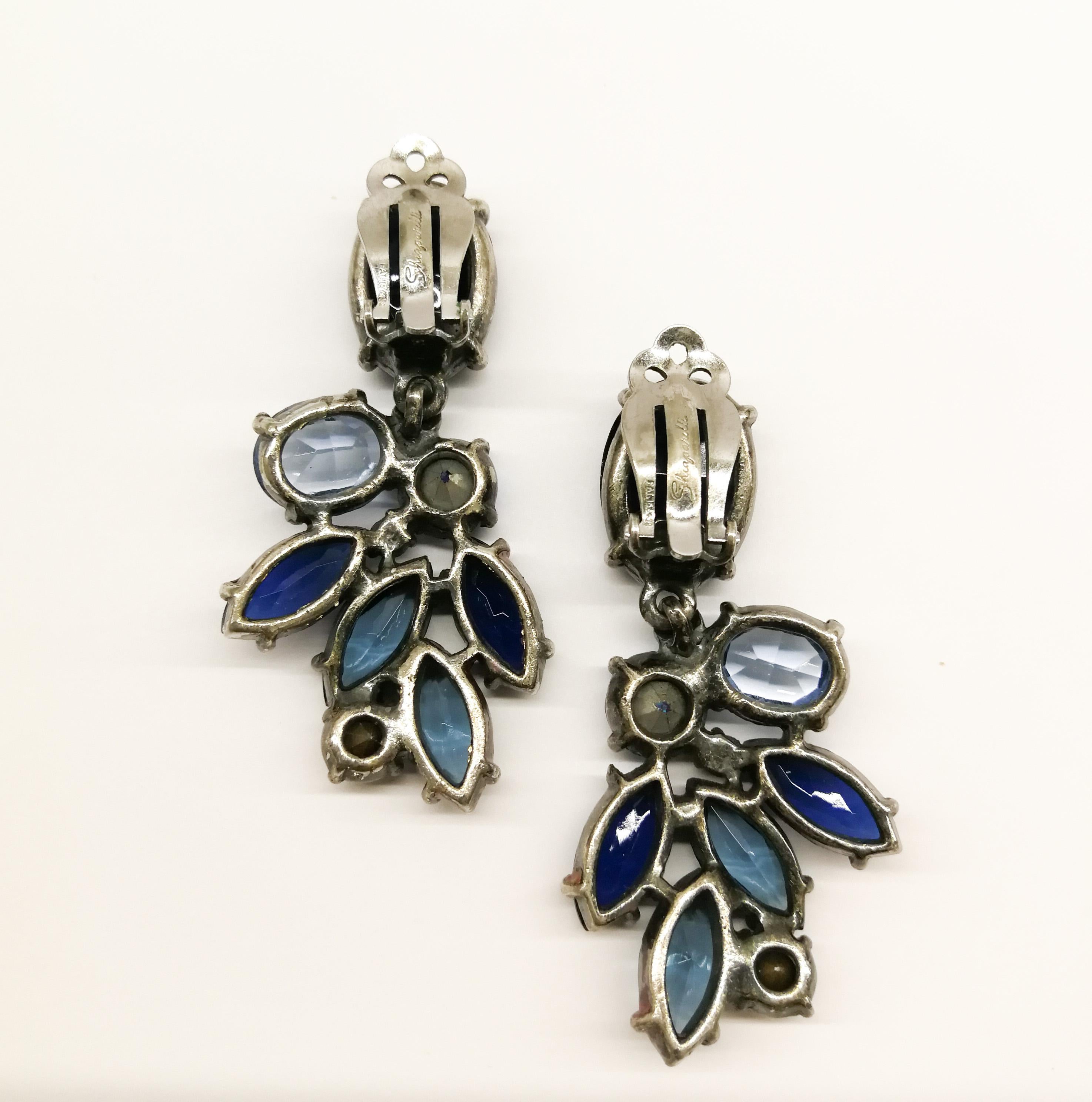 A pair of very luscious drop earrings, by Elsa Schiaparelli, from the 1950s, with assorted shapes and cuts,  and assorted shades of blue, a soft orange brown highlight, that just offsets these elegant earrings. Schiaparelli earrings from this period