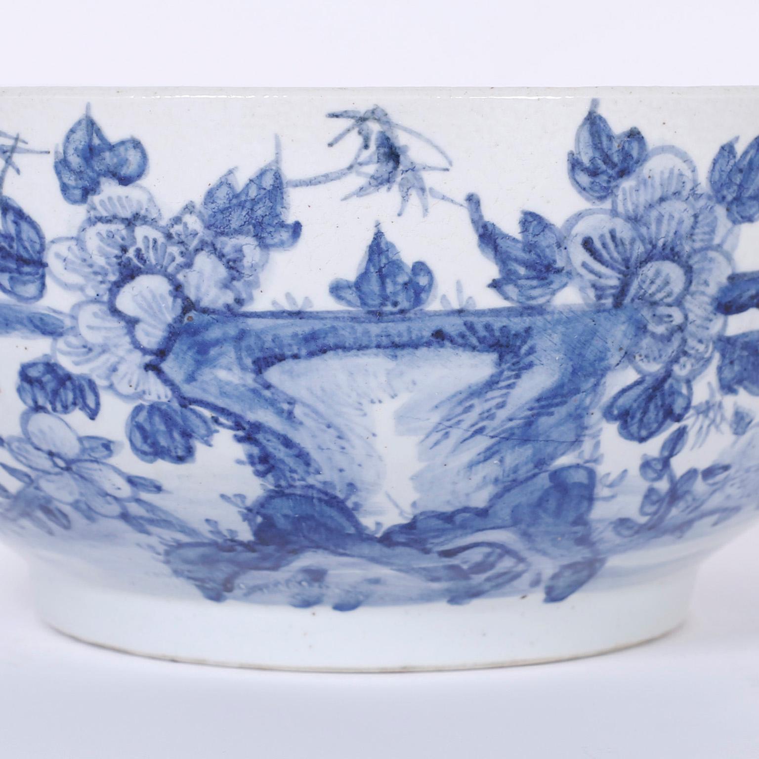 Striking blue and white Chinese porcelain bowl, in the Chinese Export manner, featuring a robust scale and decorated in front with birds and flowers, the simple back has two birds.