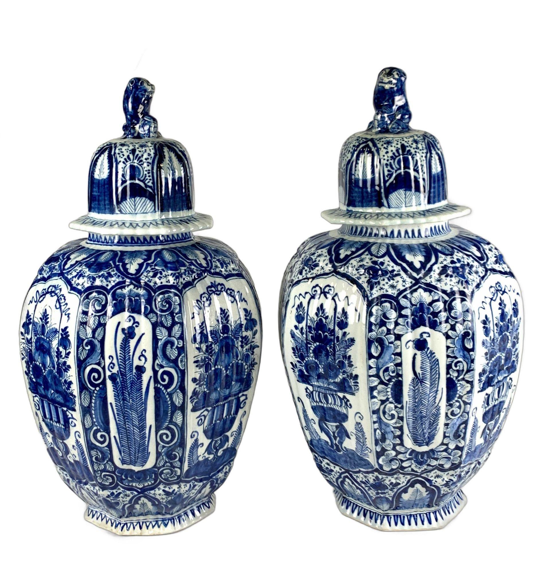 This large 18th-century pair of Dutch Delft jars is hand painted in traditional deep cobalt blue on a tin-glazed ground.
They are molded in the Delft octagonal shape with a fluted surface.
The fluting creates a beautiful effect as light reflects off