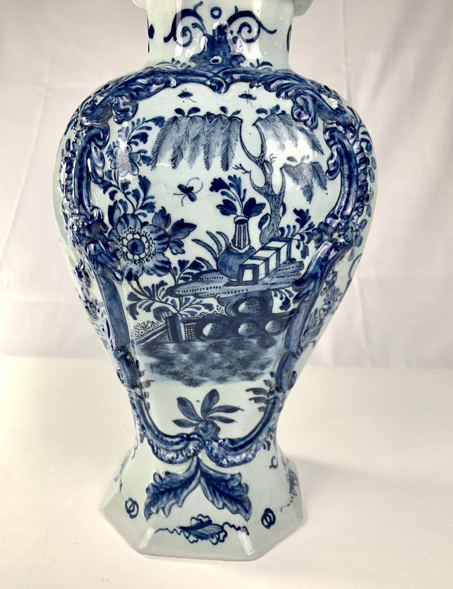 This gorgeous blue and white Dutch Delft mantle jar was hand-painted at 'T Fortuyn' (The Fortune)* circa 1780. 
The front panel features a garden scene hand-painted in deep cobalt blue, showing rockwork, a willow tree, a single large and beautiful