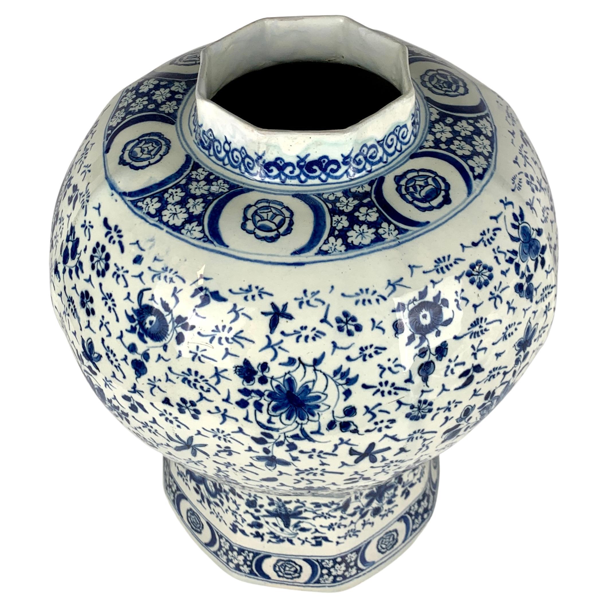 This large exquisite Dutch Delft blue and white vase is hand-painted in a medium cobalt blue with an all-around scene in the 