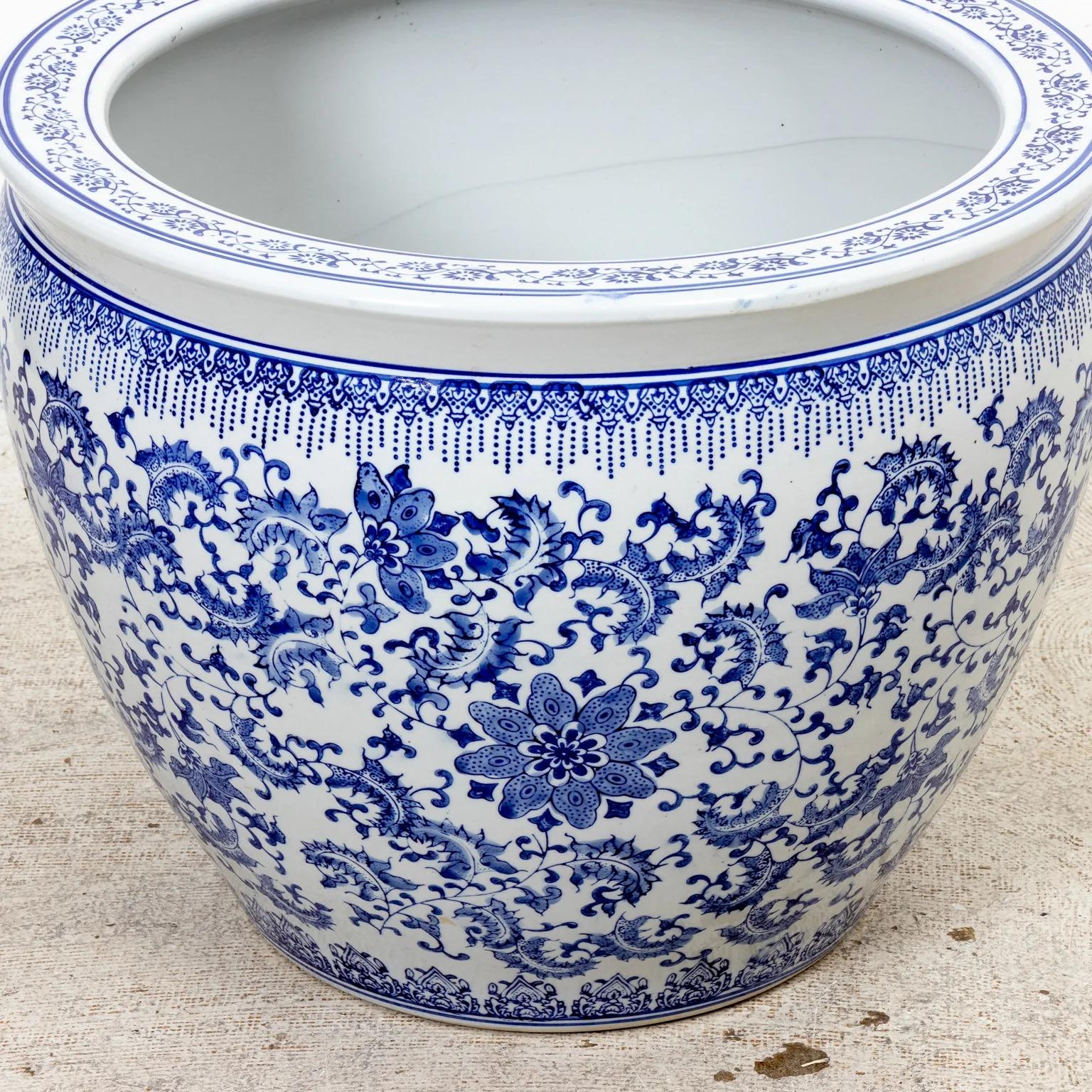 Large blue and white Chinese porcelain fish bowl or planter with foliate design. Bottom has been drilled to allow for drainage. Please note of wear consistent with age.