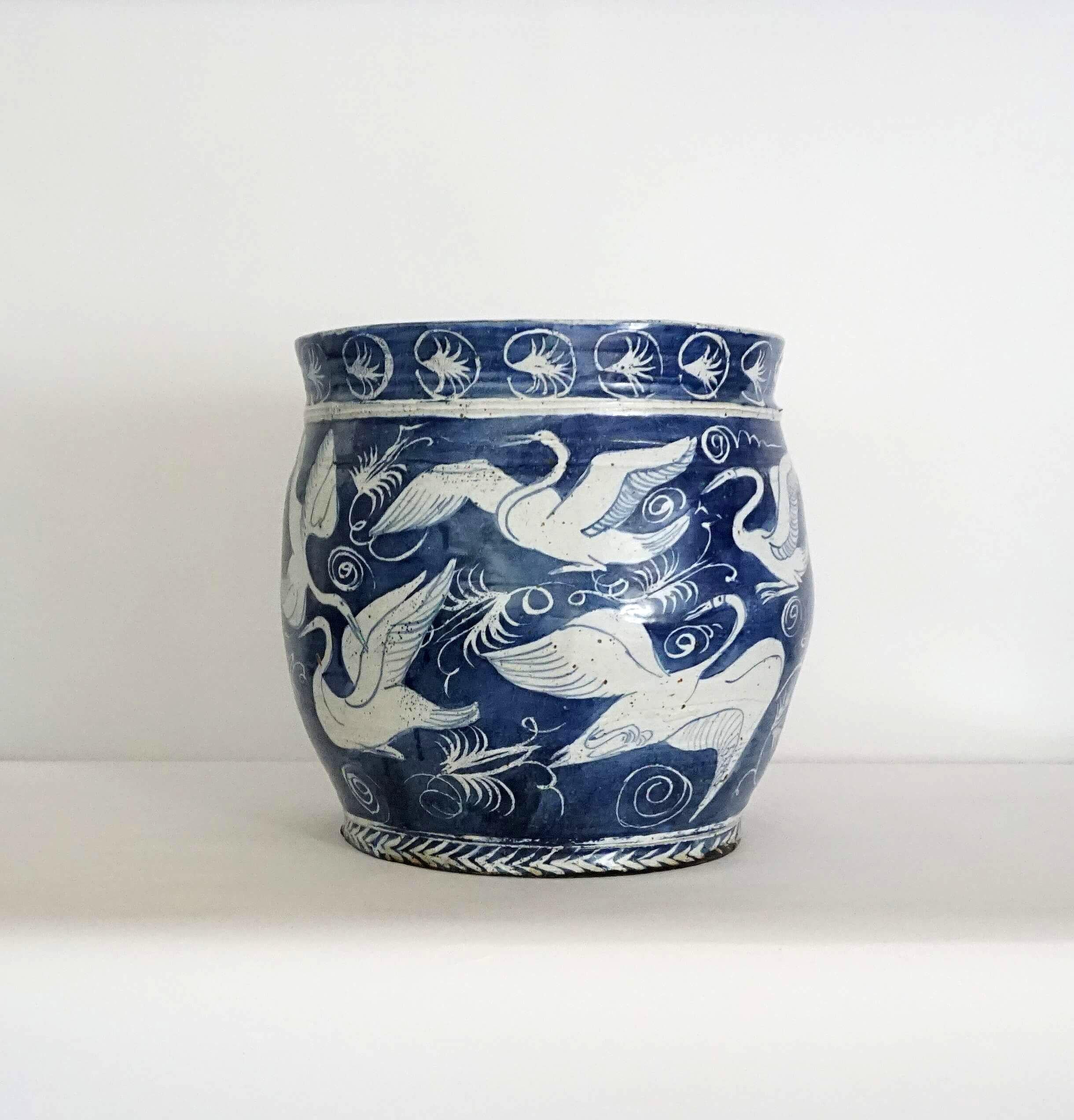 A very chic and distinctive Asian fish-bowl form planter or jardinière of large scale by late New York master potter and sculptor M. Jay Lindsay having cobalt blue and white wax resistant glaze, the gently flared rim banded with an abstract circular