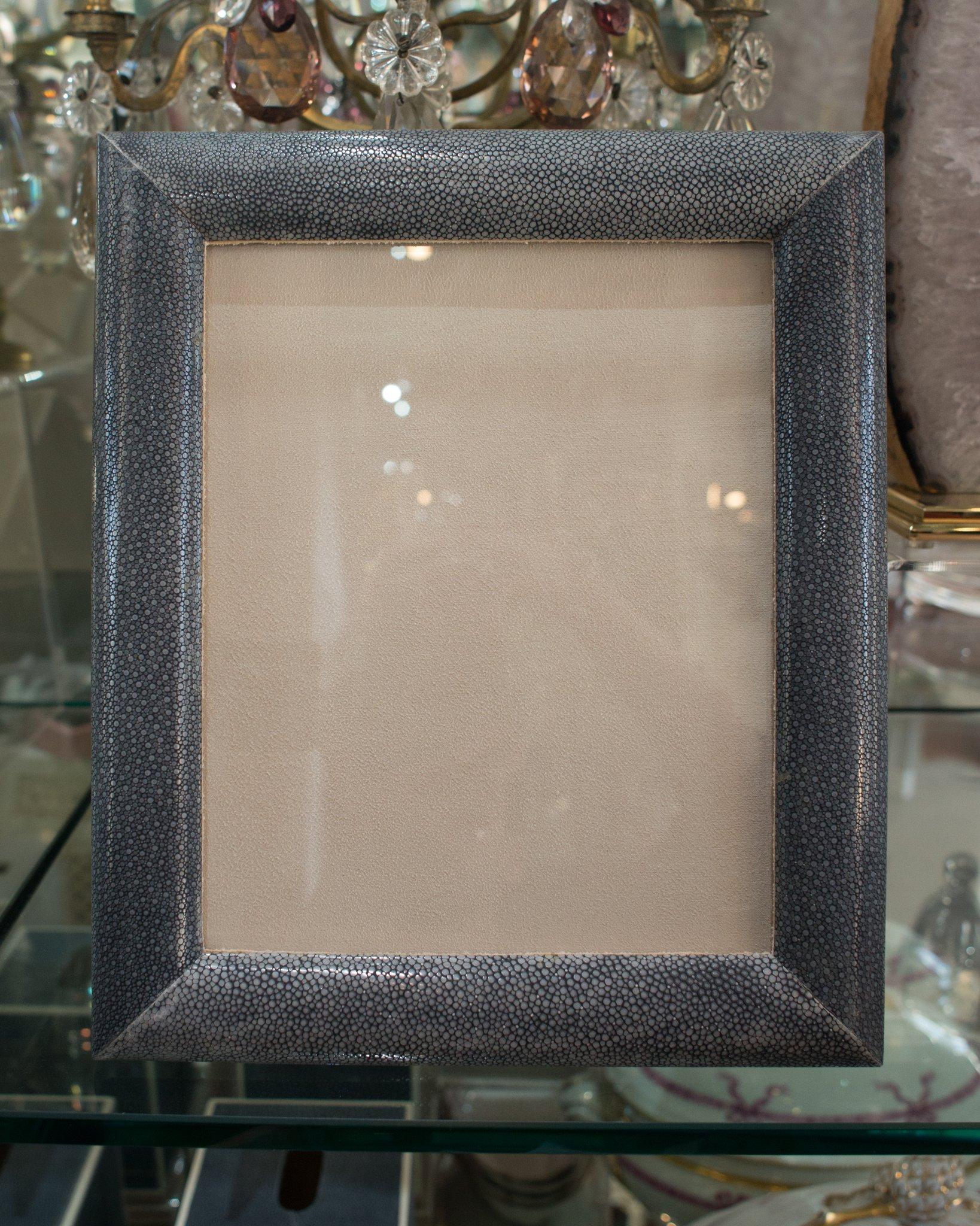 A large picture frame entirely covered in authentic blue/black shagreen on a walnut base, backed in suede. A picture frame as precious as the memory you may put inside.