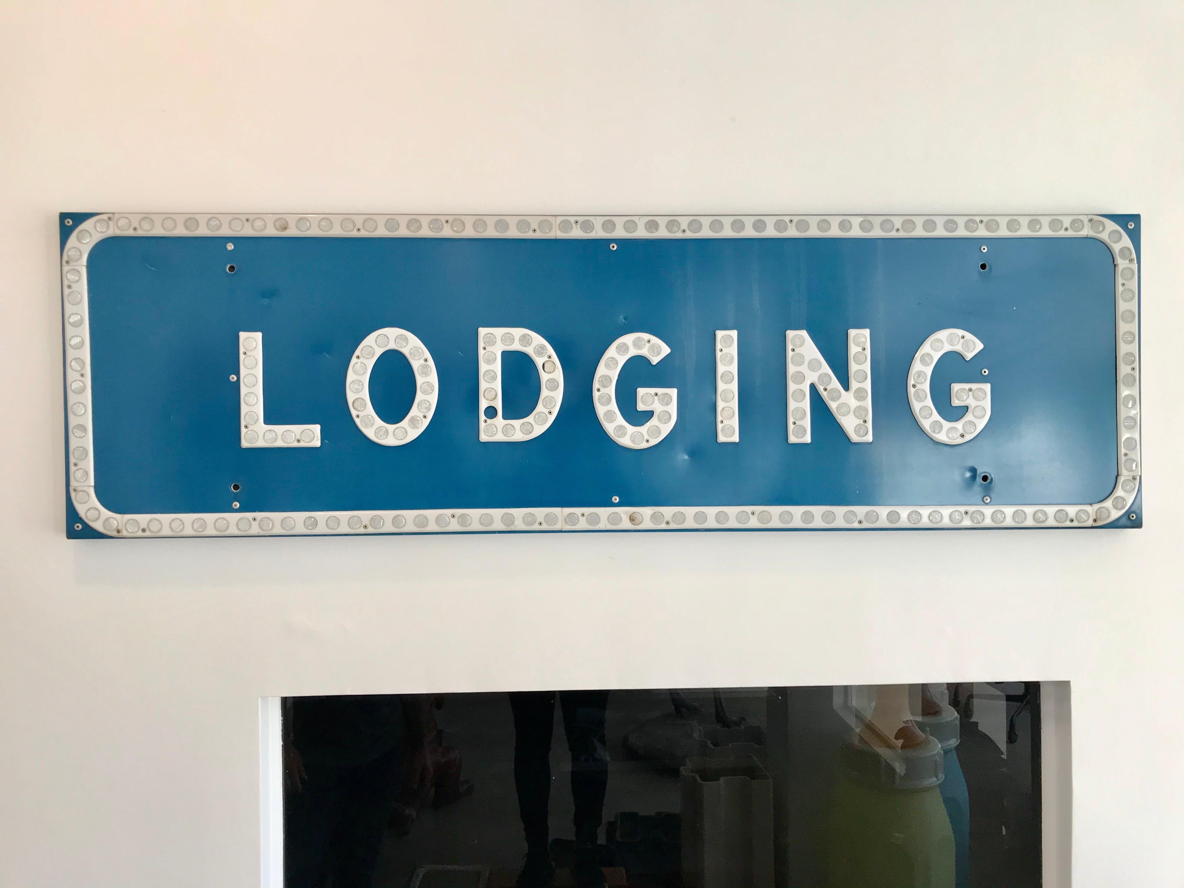 Massive vintage California lodging sign. Large blue sign with white lettering and white trim. Letters and trim have reflective pieces. Great coloring and condition. Fantastic piece of west coast ephemera. Backside is stamped 