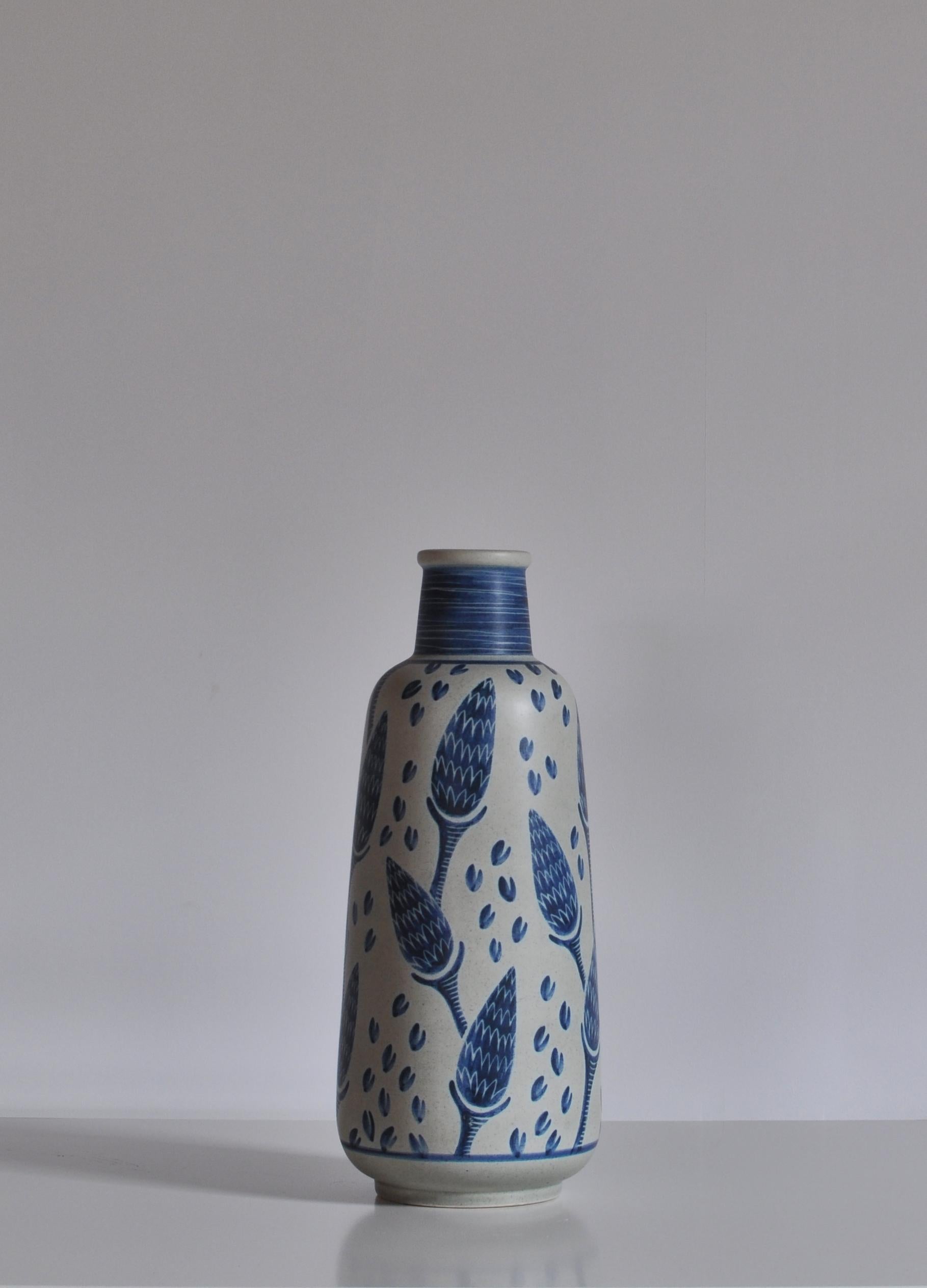 Hand painted floor vase from the 1960s by Danish artist Rigmor Nielsen at Søholm ceramics workshop, Bornholm. Each of these vases were made by hand and are unique in their decorations. This example features a beautiful corn motif in blue and white