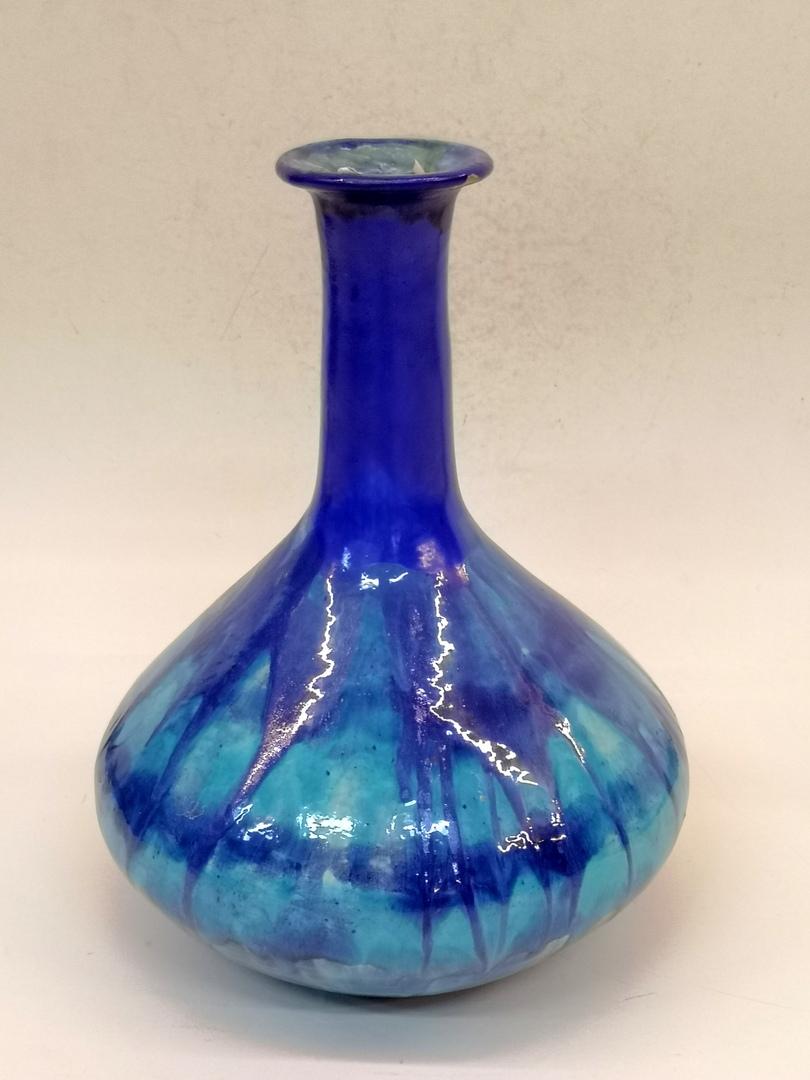 This large blue ceramic vase features a high gloss glaze and was made in the 1970s. Signed on the base.