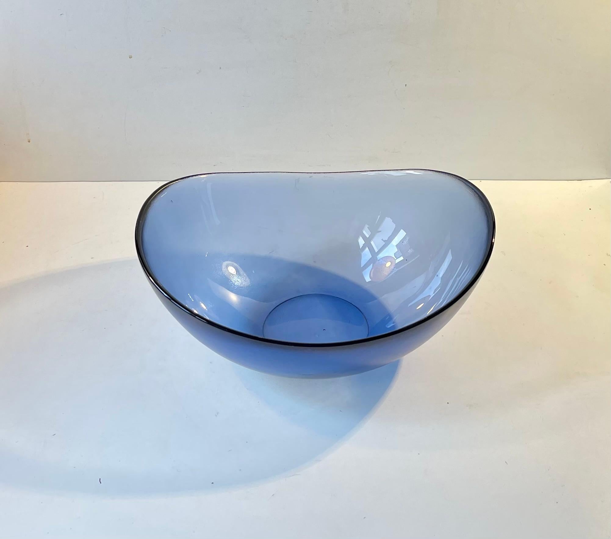Organically shaped blue bowl designed by Per Lütken during the 1980s and manufactured at Holmegaard in Denmark. It is called Verona and this one is the largest in the series. It features a micro-textured/uneven exterior and a bright contrasting
