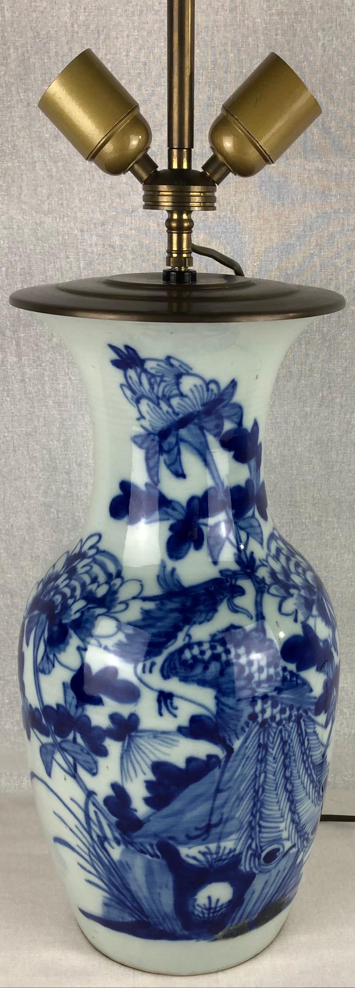 French porcelain table lamp with floral motif on blue-glaze circa 1920. This beautiful lamp is similar in style of 
early 19th Century Chinese Kangxi period vases.
 
Measurements:
31 1/2