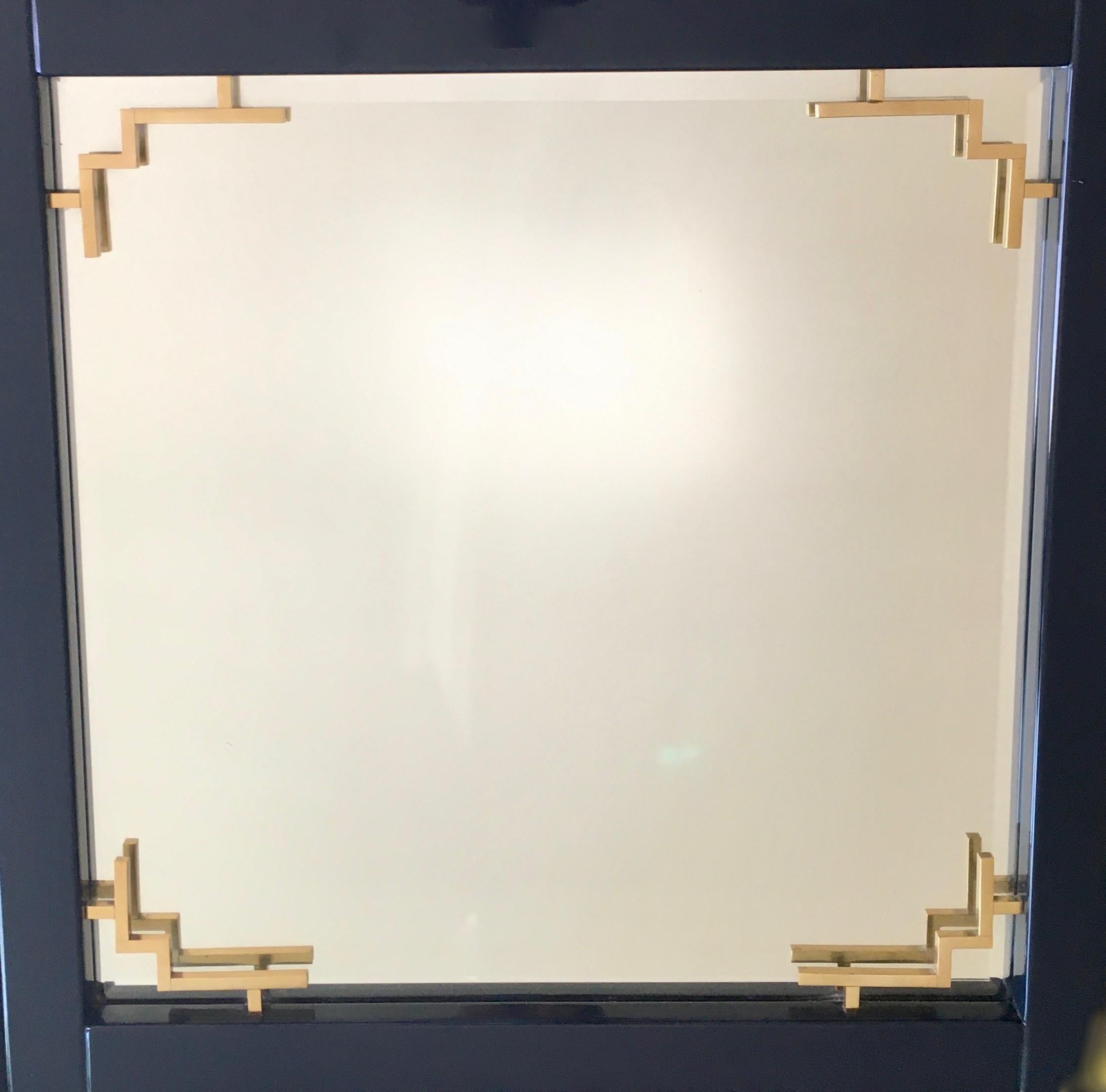 Large square mirror with fine Asian inspirated brass accents.
Deep blue lacquer frame.
By Maison Jansen, 1978.