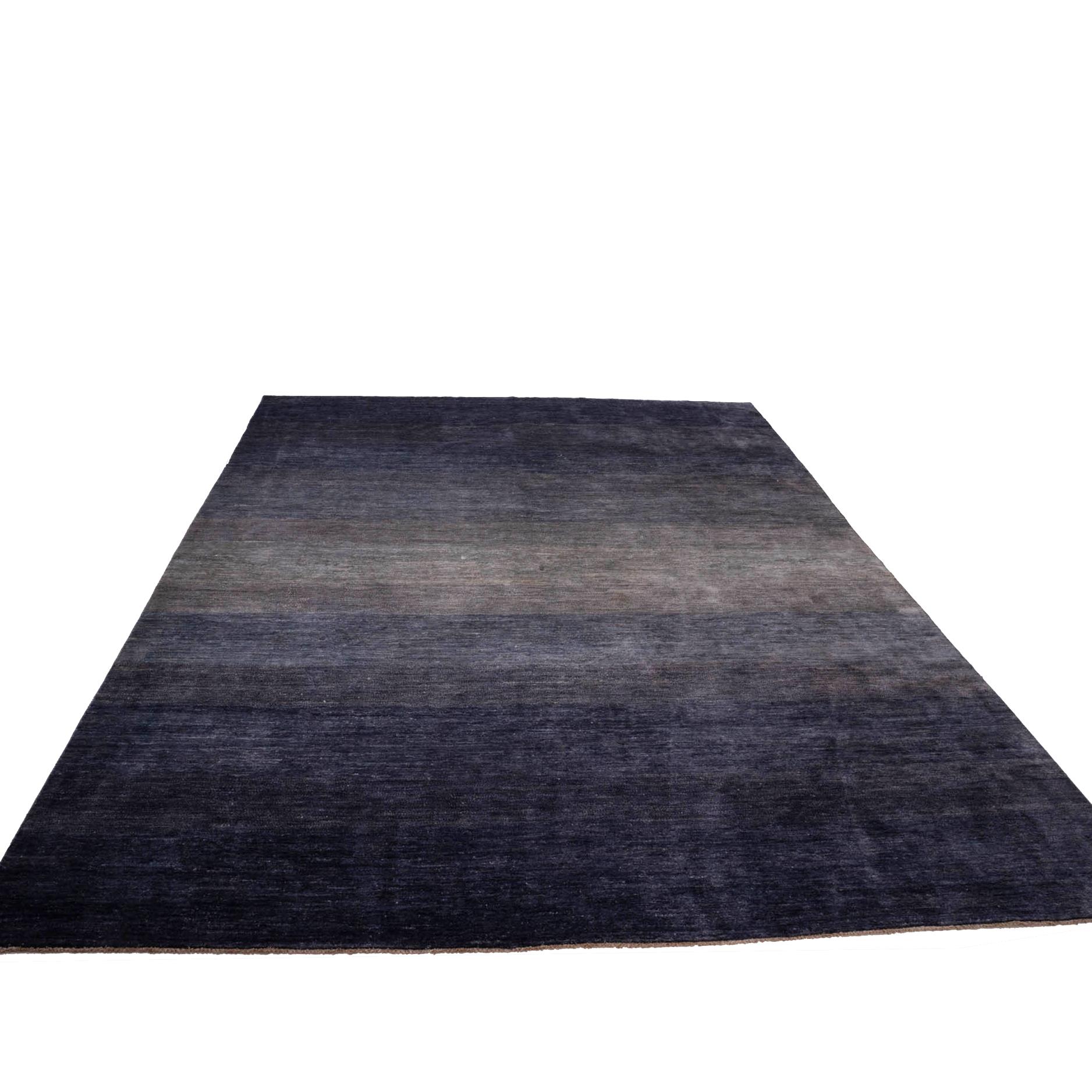 This beautiful hand tufted blue rug features a gradient of blue colours that range from a darker rich blue through to a lighter blue in the middle section, including sections of white. This gradient creates a depth and texture, evoking images of the