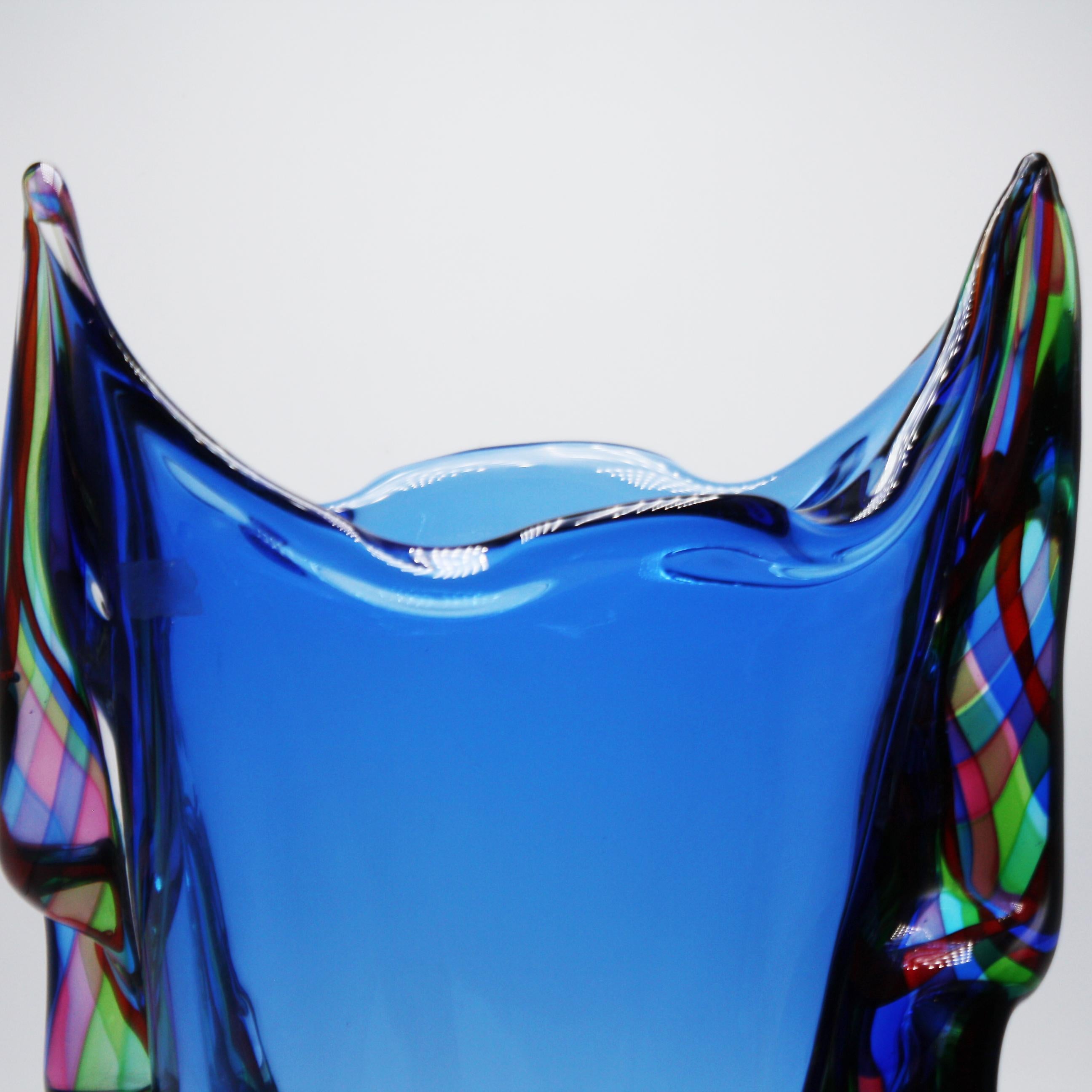 A beautiful large scale Murano vase with an ombre blue glass center.  Multi-colored ribbon detailing along each side.  Murano, Italy c. 1970.
