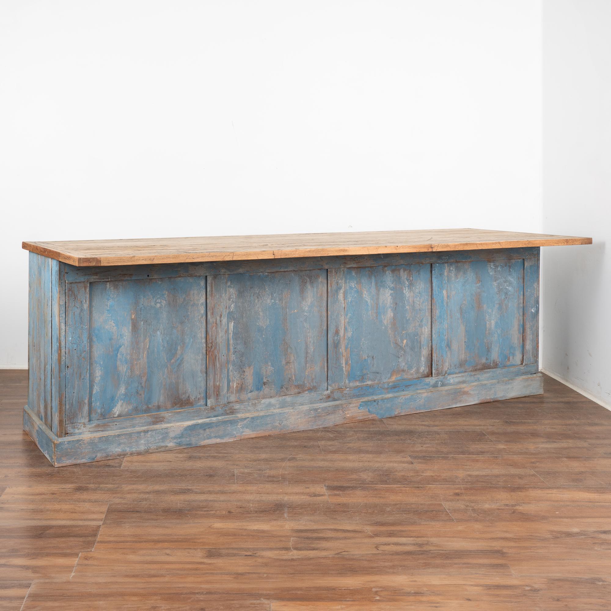 This old shop counter from Sweden will serve well as a modern 9' kitchen island.
The top is made from old boxcar flooring (from a train); thick and heavy, it is filled with gouges and stains from years of use in train yards and provides a wonderful