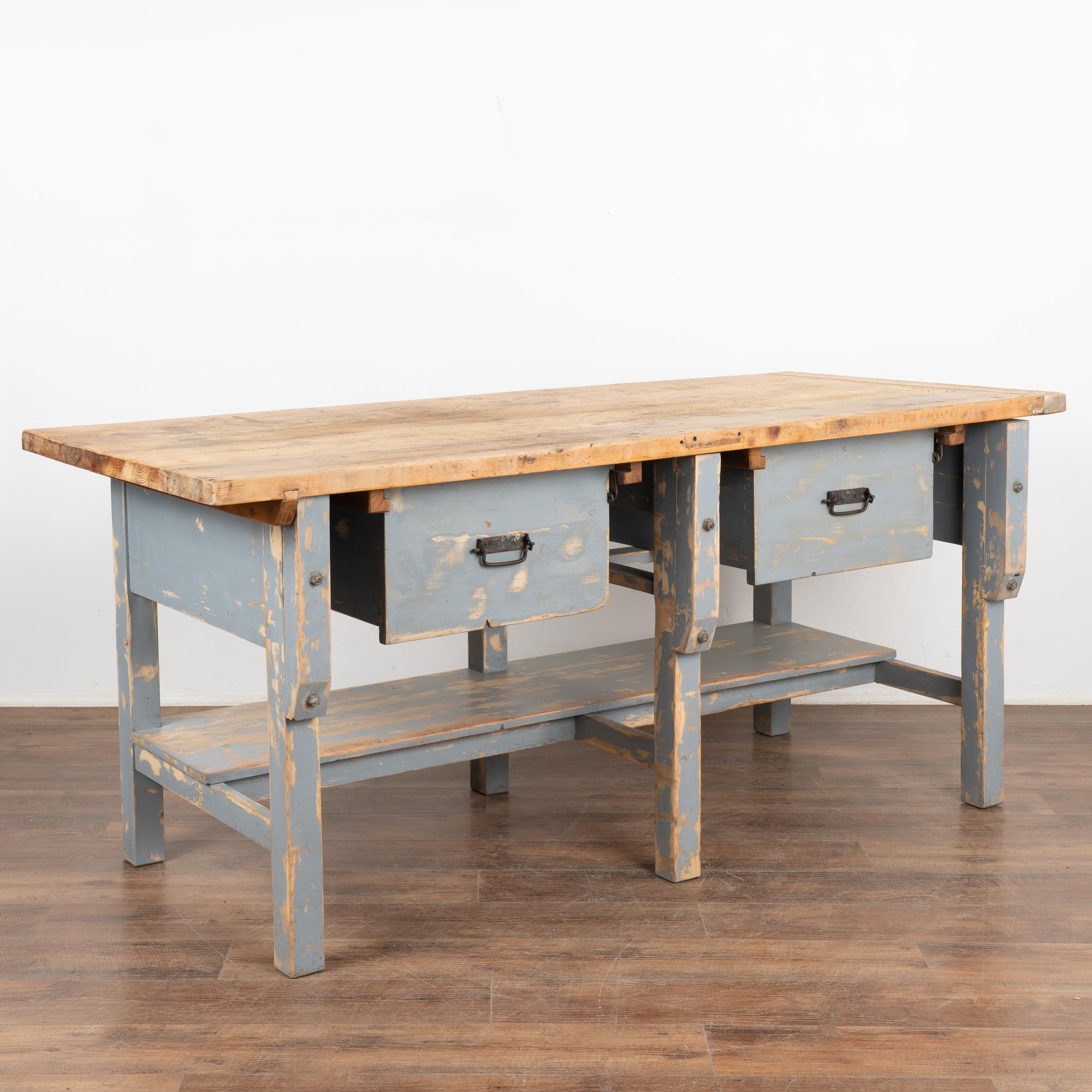 Rustic work table or shop counter with two large drawers and lower shelf. The blue painted finish has been distressed throughout the base. 
This heavily used 6' table reflects generations of use in every gouge, nick, scratch, stain and small holes