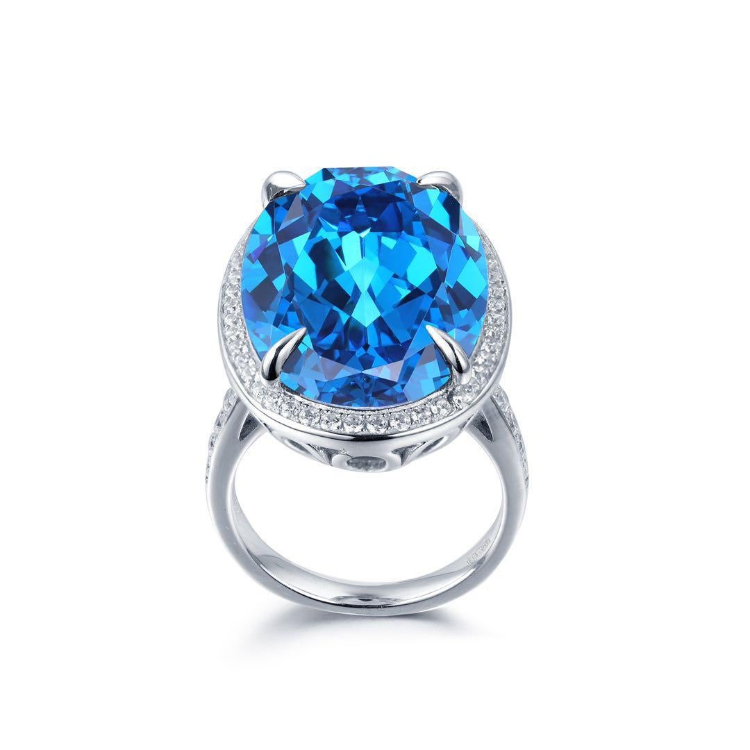 Beautiful large simulated blue topaz ring in colour London blue with white cubic zirconium around. Stone dimensions - 220 x 160 mm. Ring is made of 925 silver and rhodium pleated, so won't tarnish.
It is going to compliment both evening and casual
