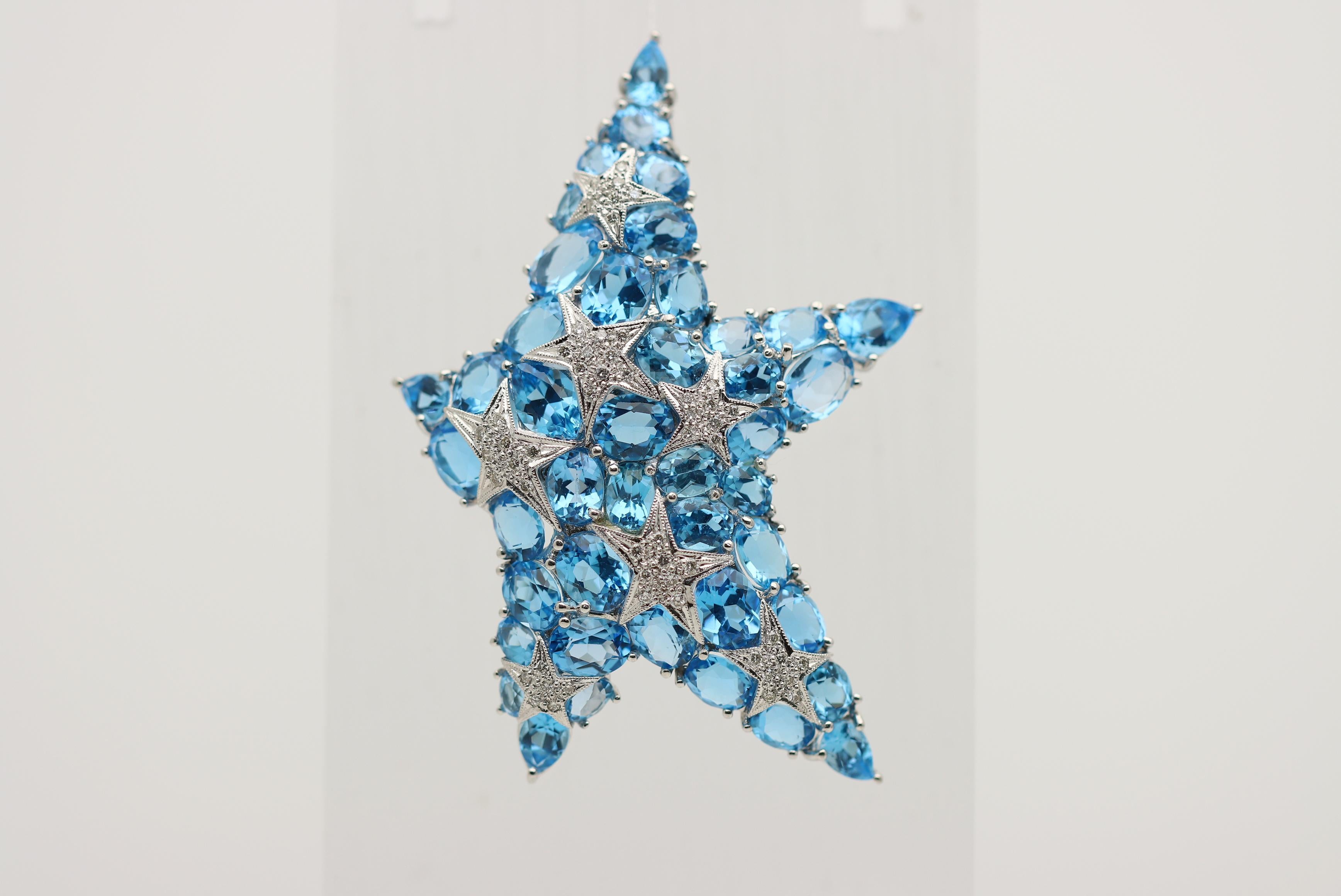 A large, unique, and stylish brooch featuring a blue topaz and diamond studded starfish! There are a total of 39.25 carats of bright sky-blue topaz in a variety of shapes, mainly oval-shape along with pear-shapes set on the ends of the star’s