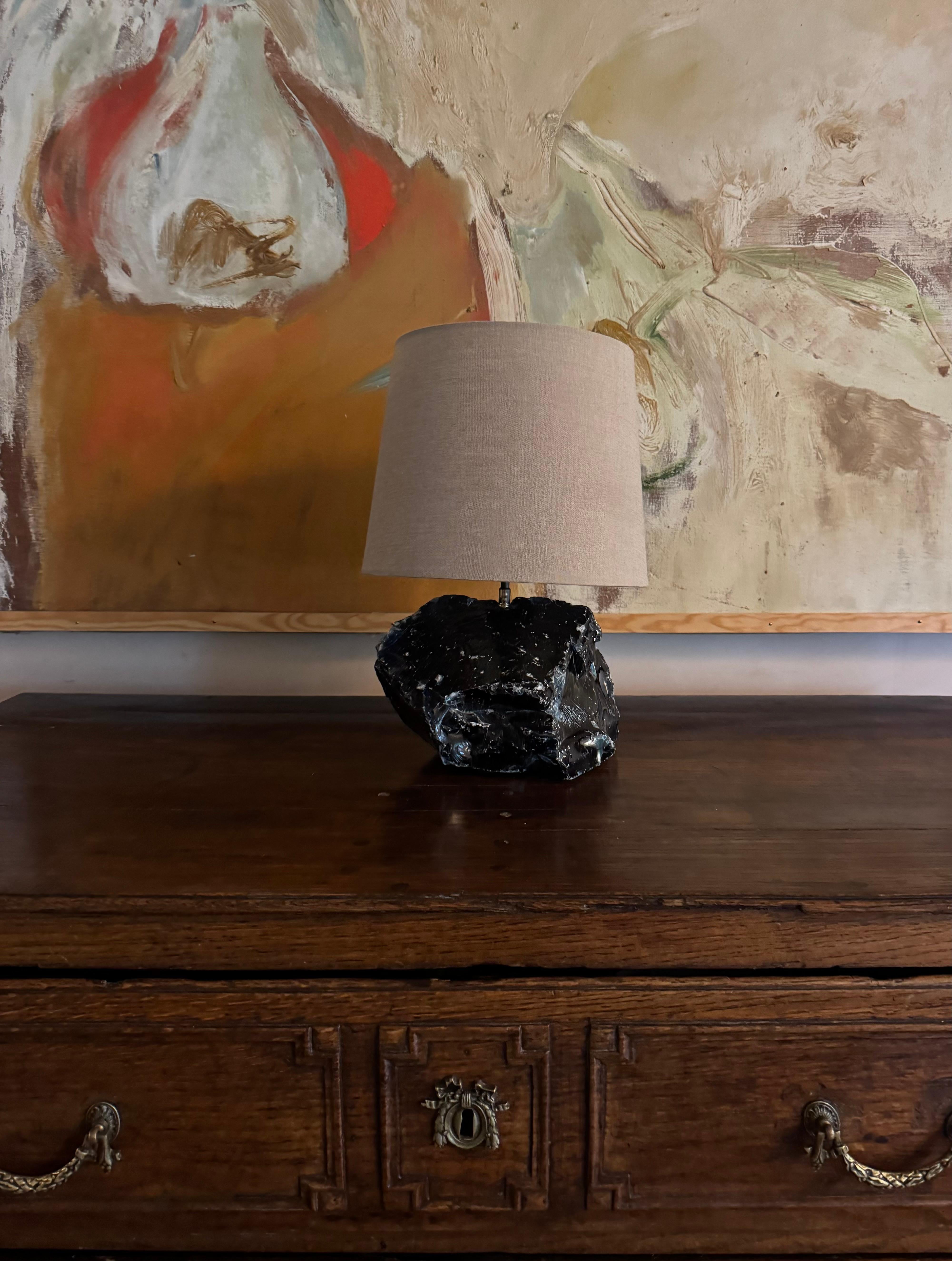 A blue slag rock lamp base after a design by JM Frank. Great deep blue colour. Patinated brass collar. Shade for display not included.