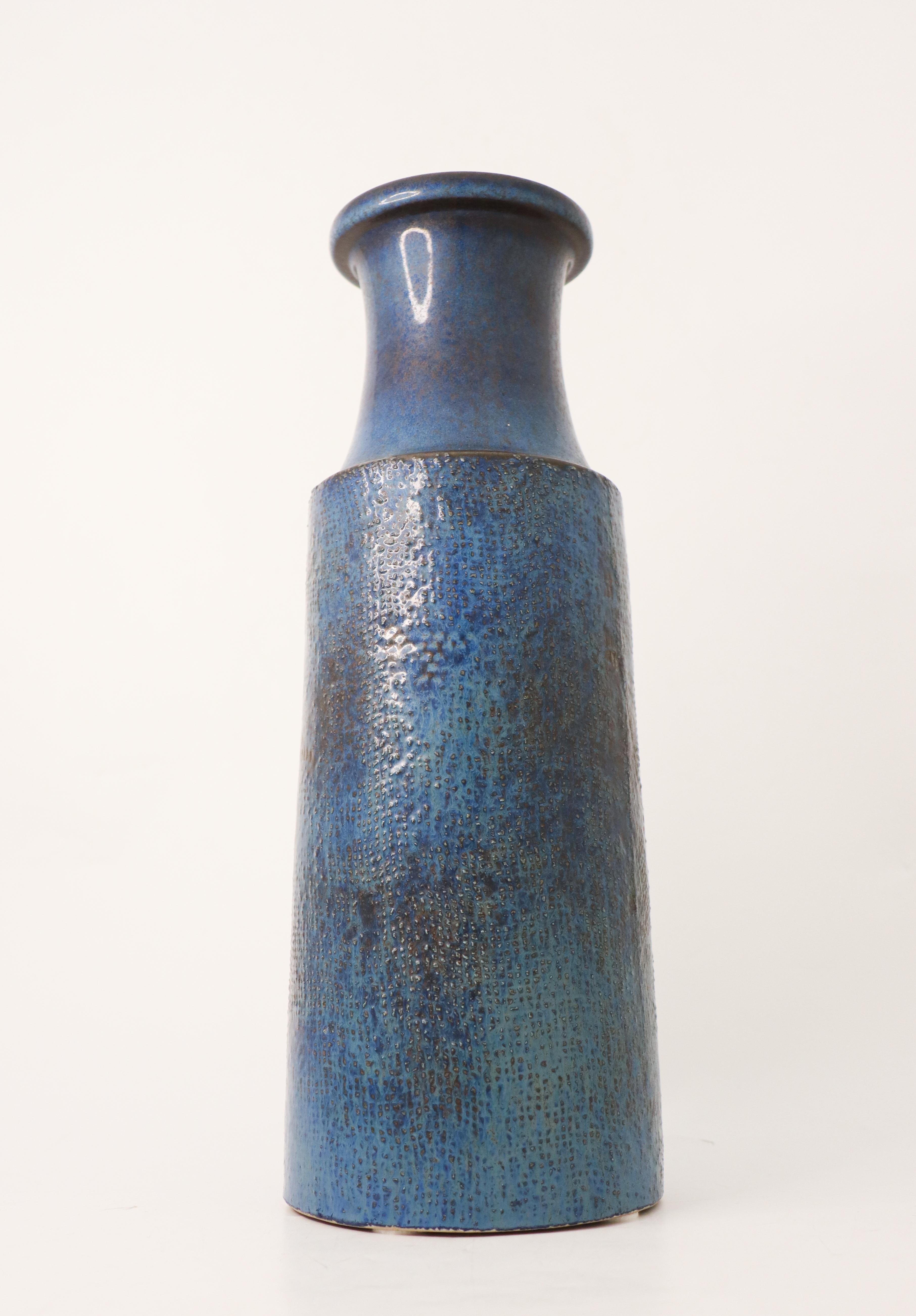 A large blue stoneware vase with a relief decor designed by Stig Lindberg at Gustavsberg. It is 39 cm high and in very good condition. This vase was designed in 1964.