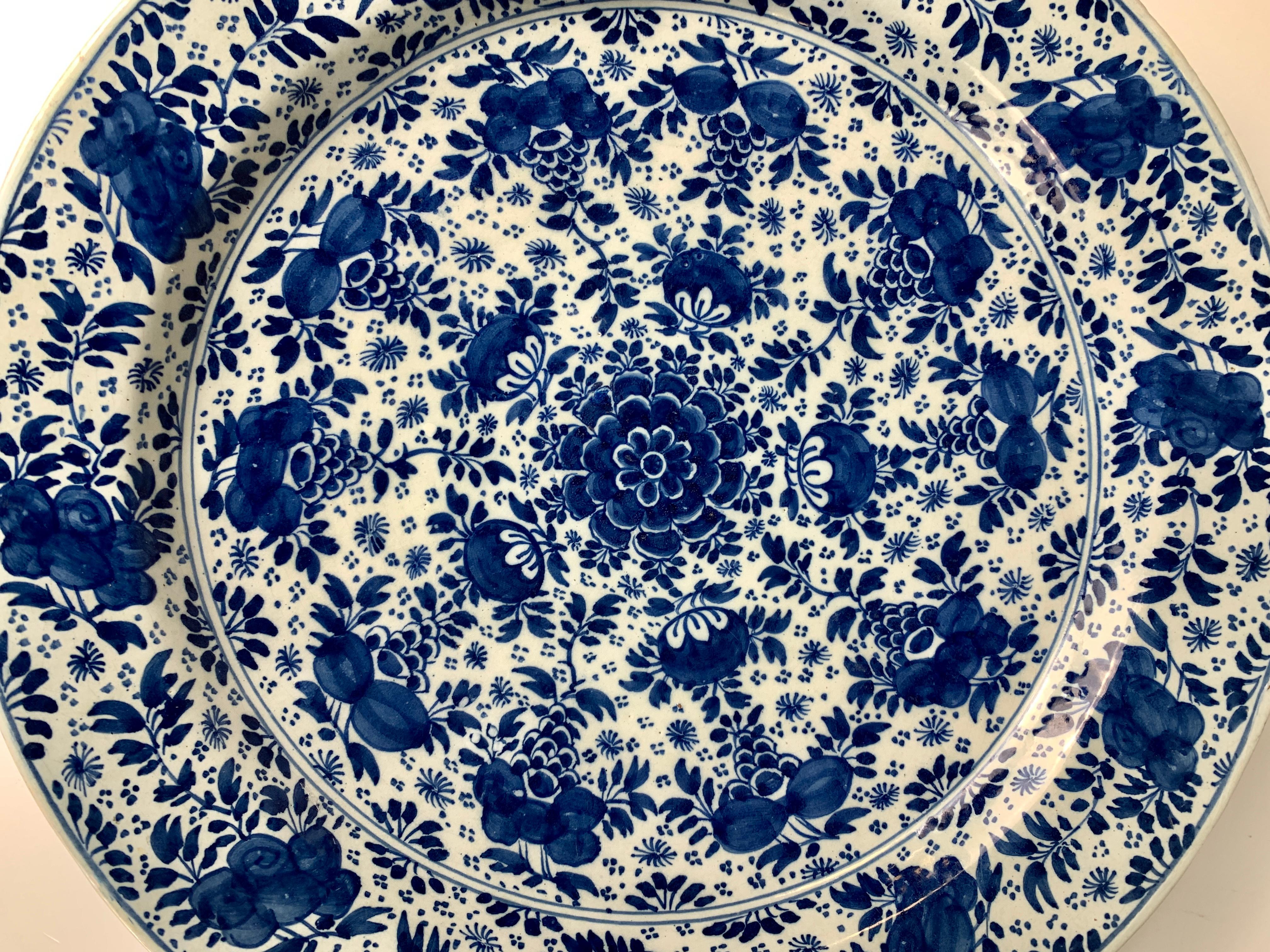 A huge blue and white Delft charger hand-painted in cobalt blue with peonies encircling a central flower.
Made in the Netherlands circa 1760, the charger is decorated all over with flowers arranged in a floral pattern (see image #2)
The reverse of