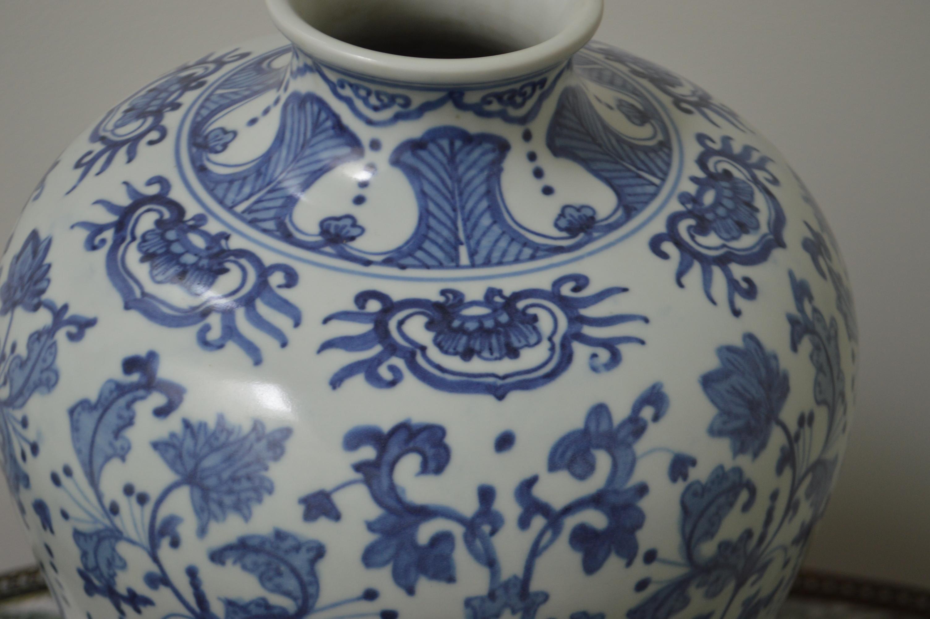 Highly decorative large floral blue and white porcelain Chinese vase. Apocryphal Quianlong at base. The floral design is in light and dark navy blue.
   