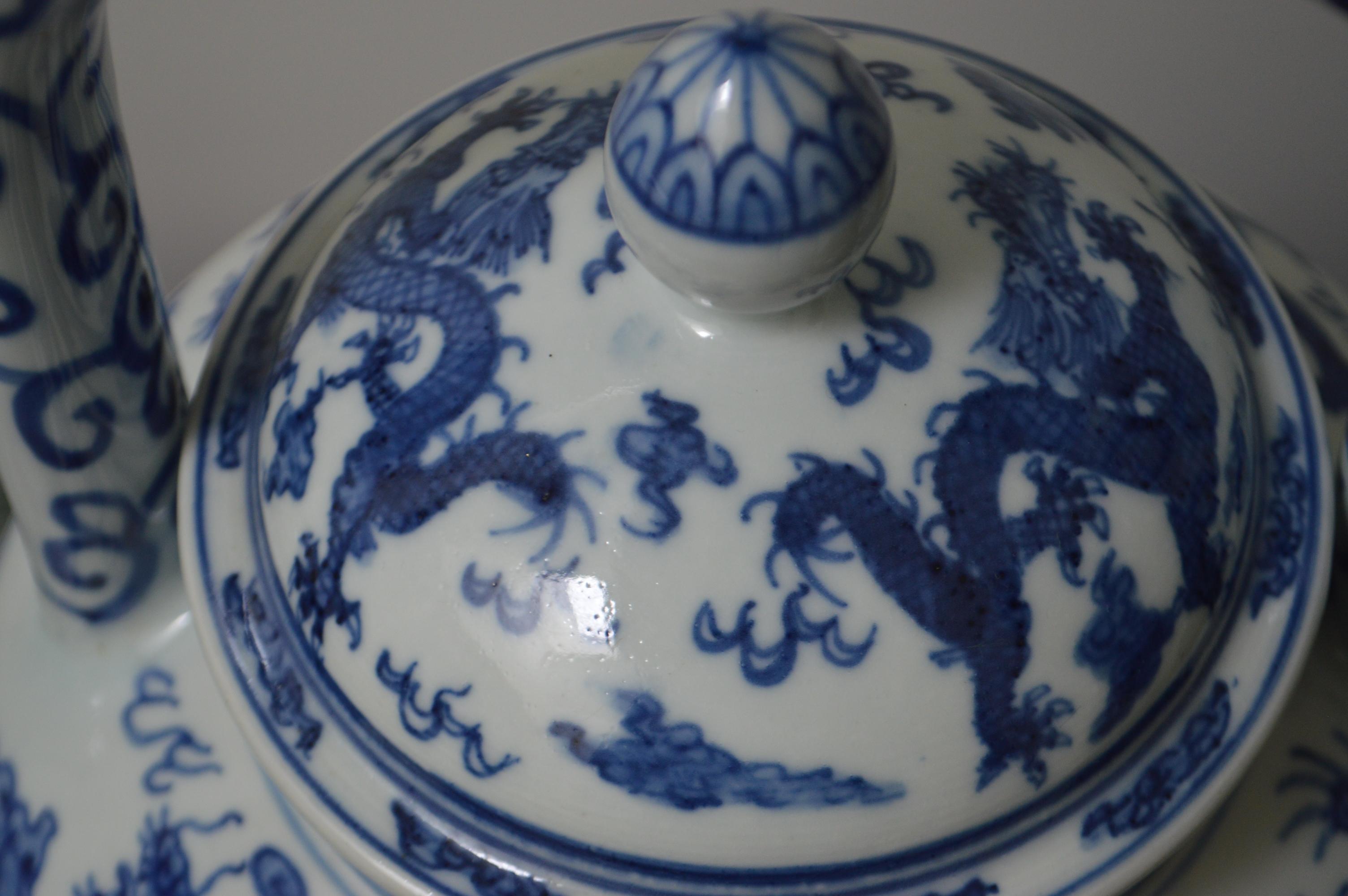 A large blue and white porcelain tea pot with large top handle, lid and dragon motif. It also has an Apocryphal Longging mark on the bottom. Excellent condition.