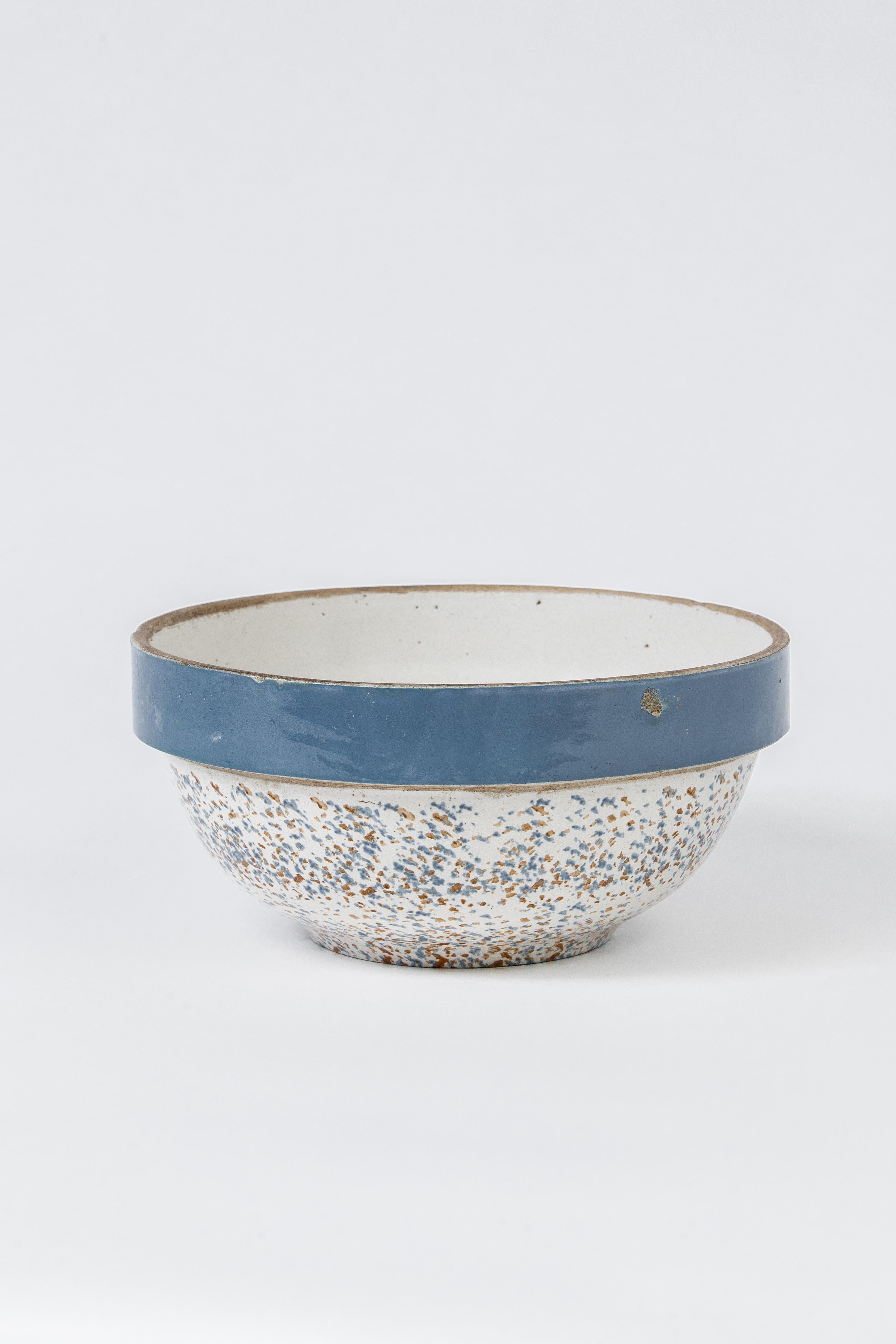 A large rustic vessel in blue and white glaze with sponge applied decor.