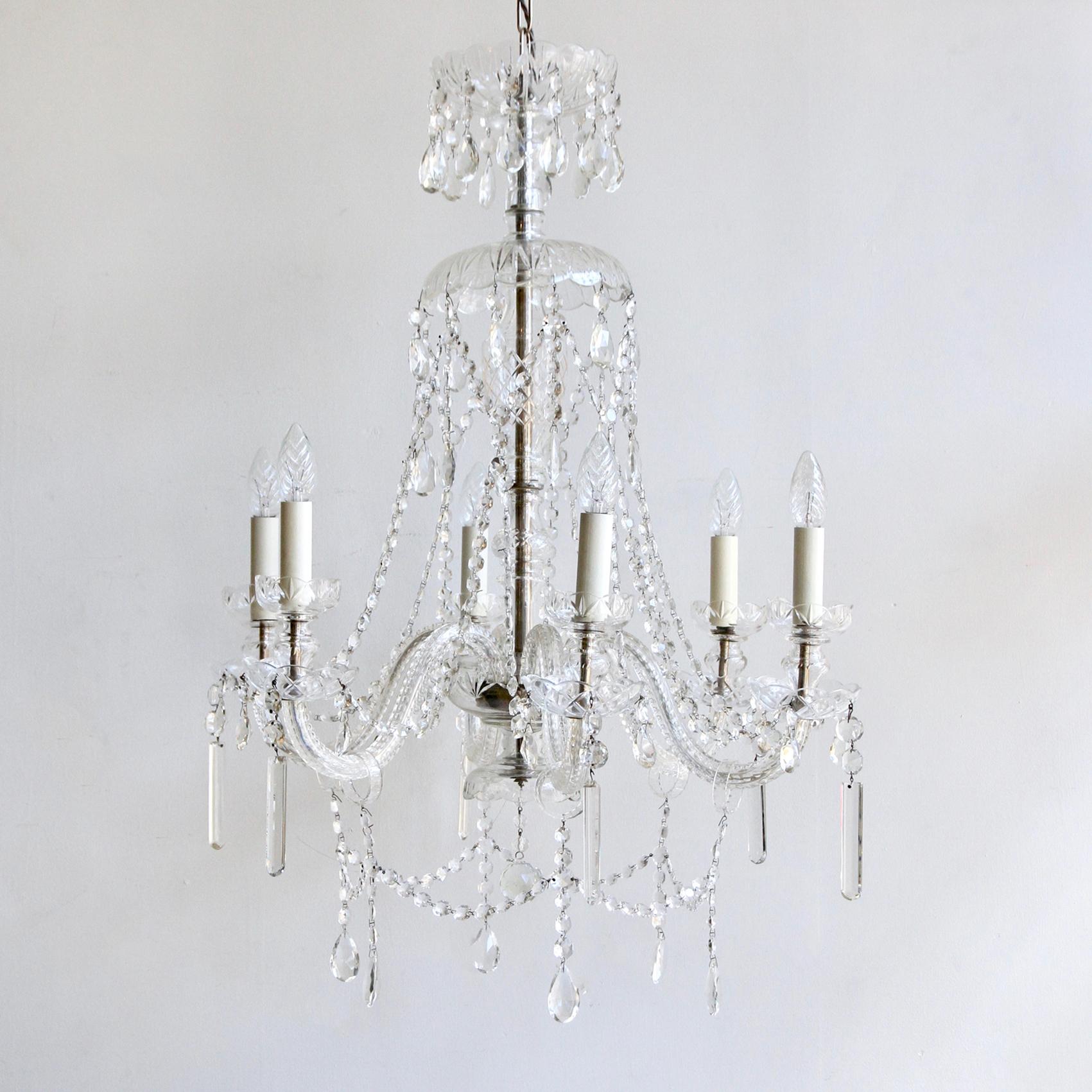 This large Bohemian crystal chandelier originates from Czechoslovakian circa 1930s. It's elegant crystal swan neck arms hold six lamps. Dressed in unique cut crystal drops with crystal buttons. The chandelier comes supplied with braided flex and