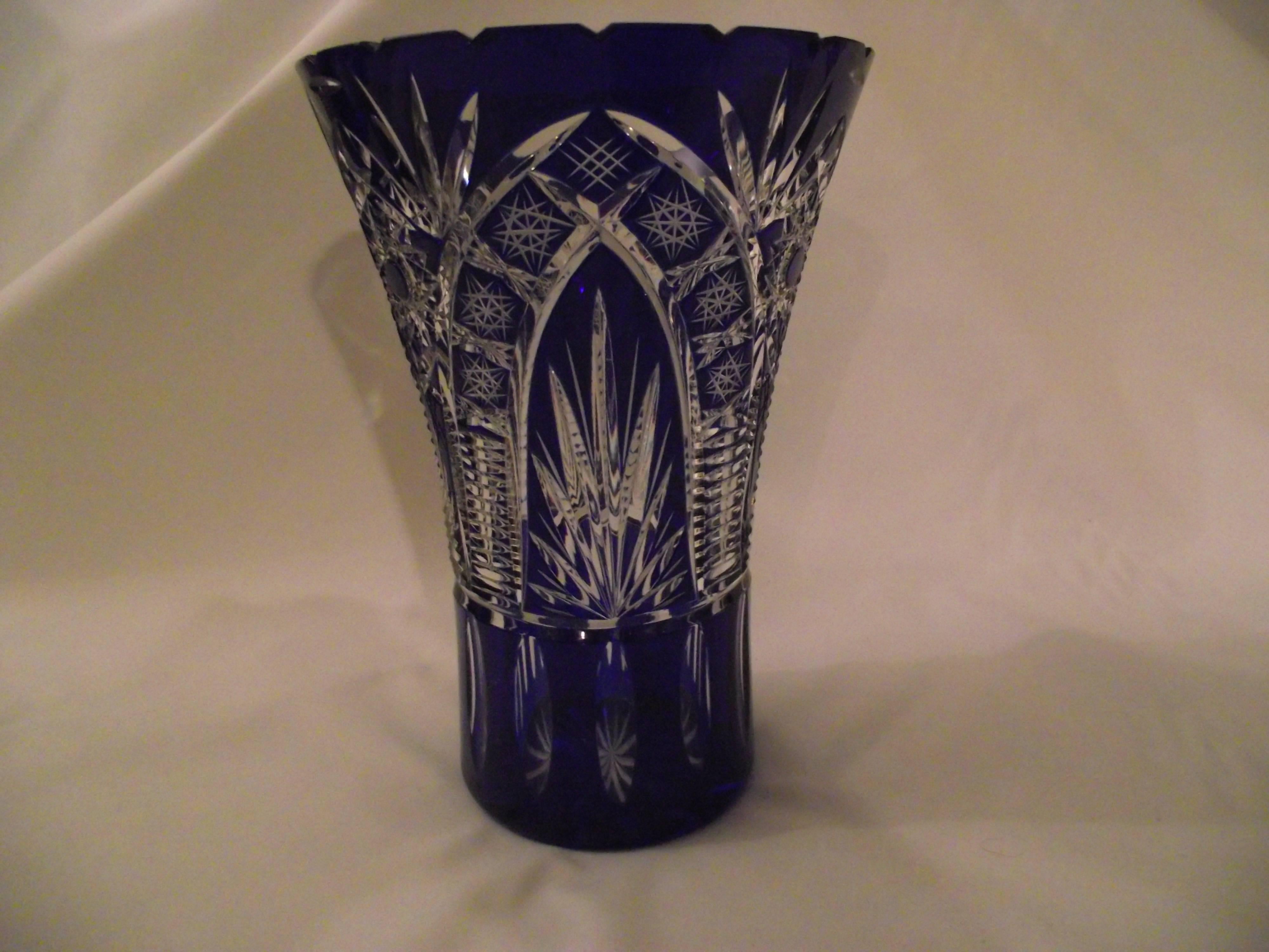 This large cut crystal vase is heavy enough to hold large flower arrangements. It is in perfect condition.