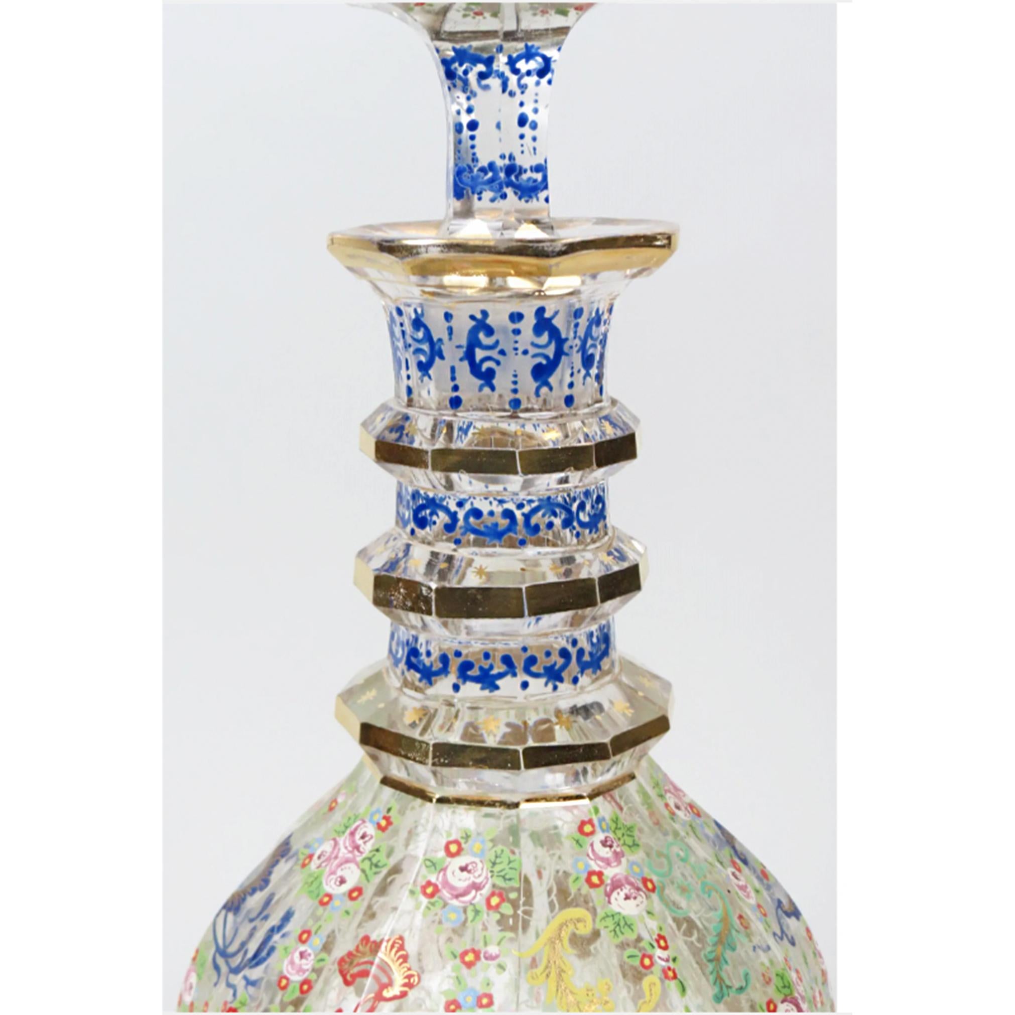 Large Bohemian Enameled Glass Decanter, panel cut with central golden medallions, royal blue and gold leaf multi ring neck. Wrapped in elaborate and decorative floral designs designs. 

Date:  19th century

Dimensions: 17 1/2