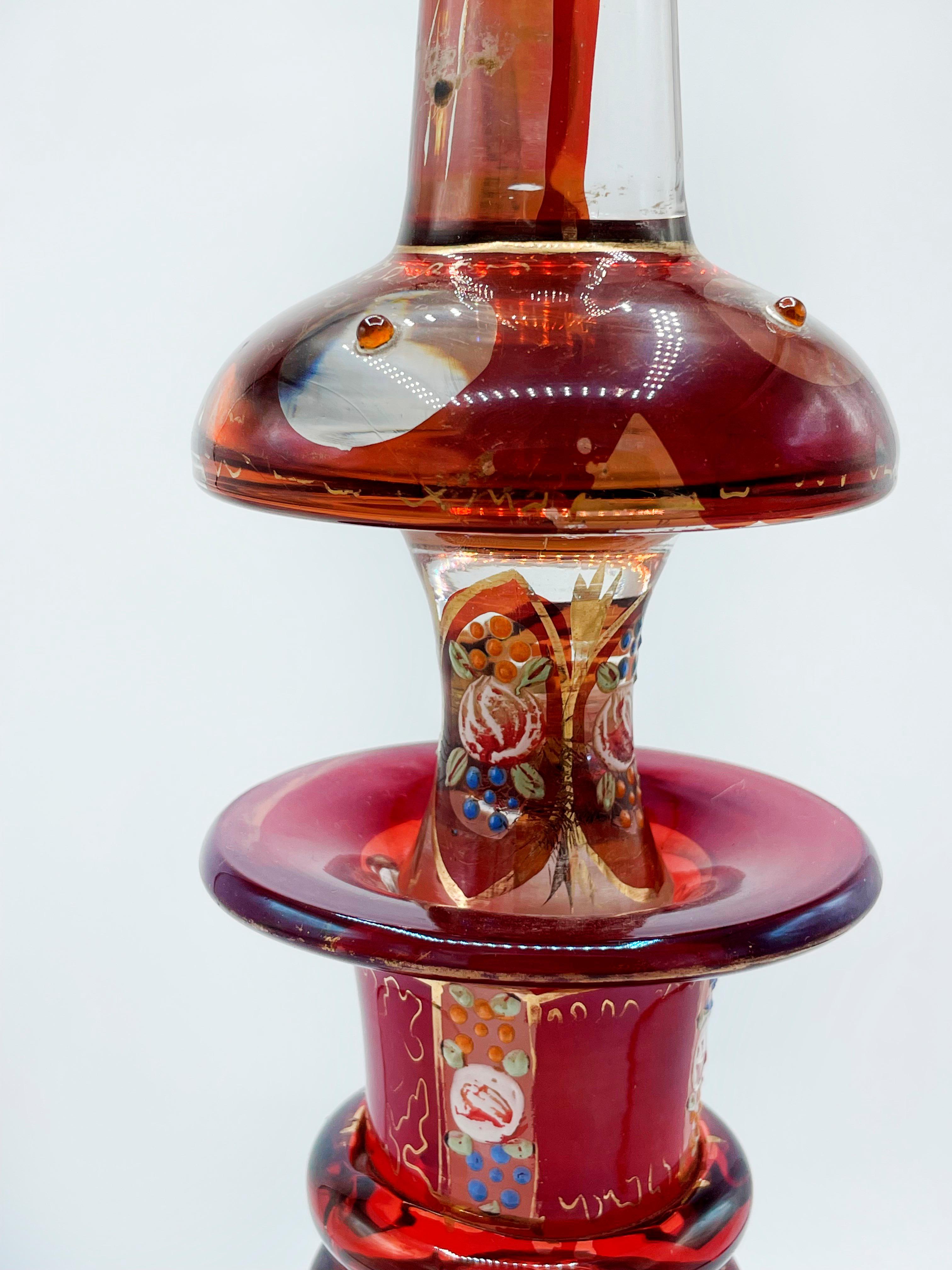 Large Bohemian in crystal, Enamelled and Cut Red Overlay Glass

Measures:
57 centimeters high
 16 centimeters diameter

This beautiful decanter was created in Bohemia (modern-day Czech Republic), a region which was famous for its decorative