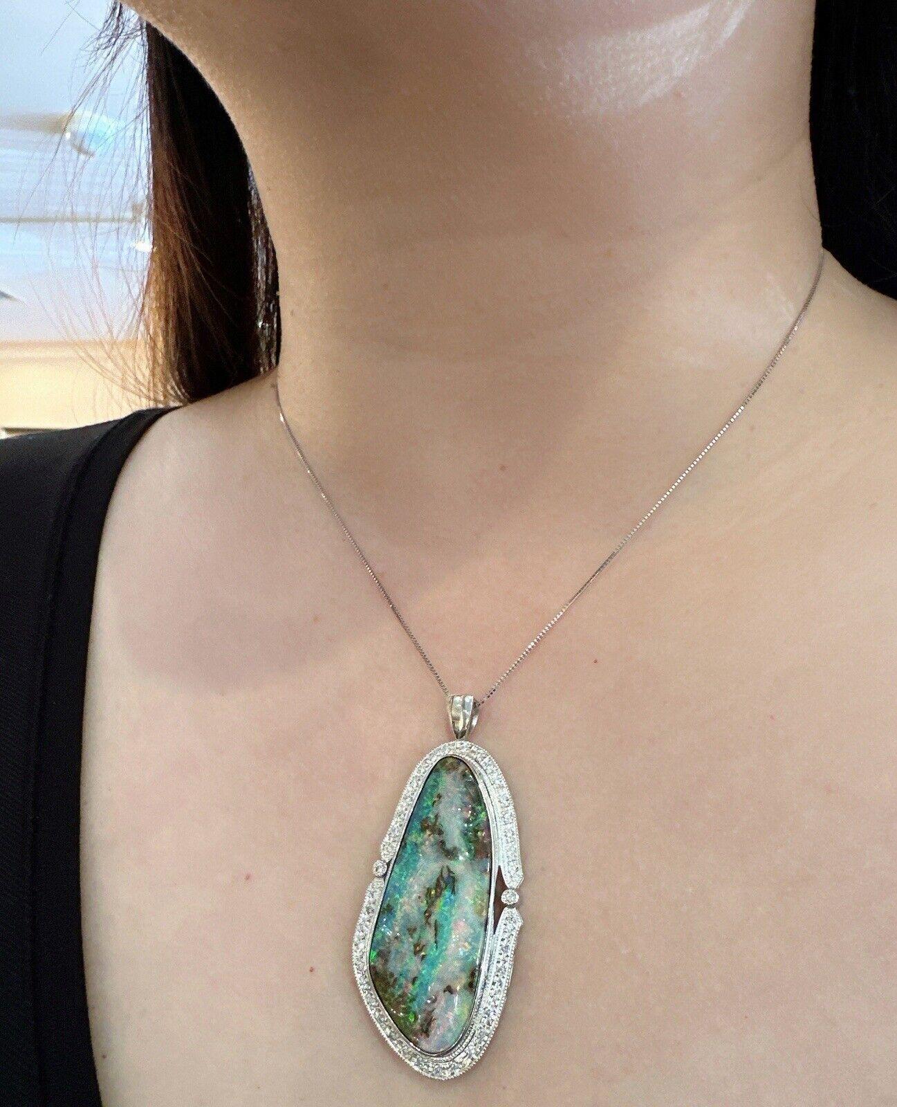 Large Boulder Opal and Diamond Pendant Necklace in Platinum 

Boulder Opal and Diamond Pendant features a 48.50 carat Boulder Opal with Natural Round Diamonds set in Platinum with a Platinum box chain.

Total opal weight is 48.50 carats.
Total